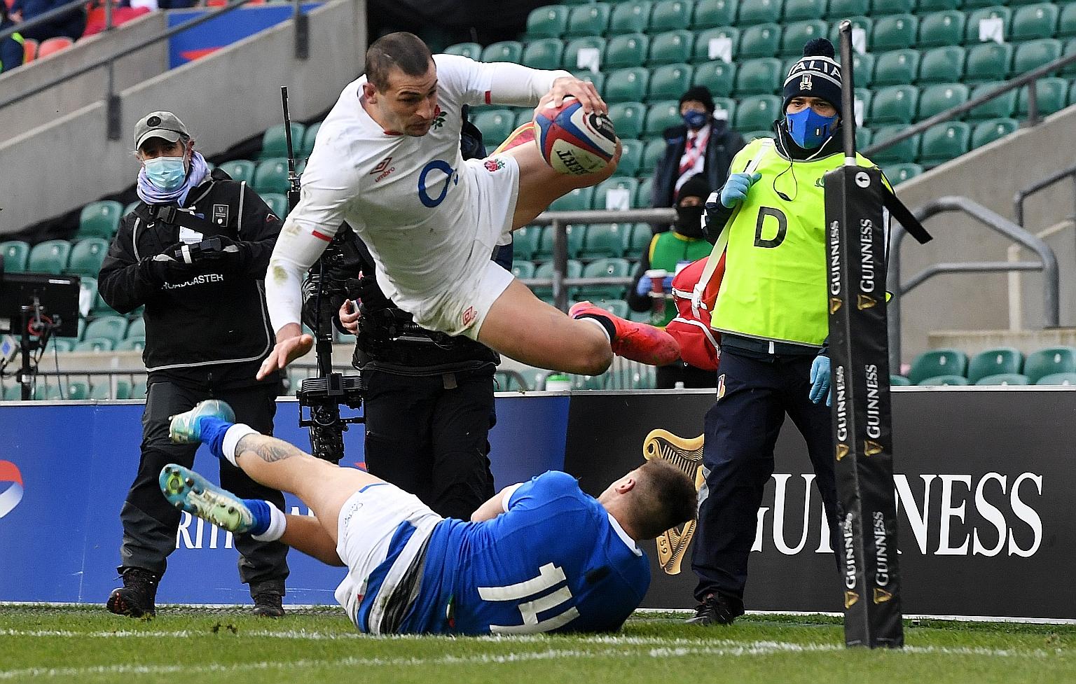 England winger Jonny May avoiding Luca Sperandio's tackle to score a try during their Six Nations match against Italy at Twickenham on Saturday.