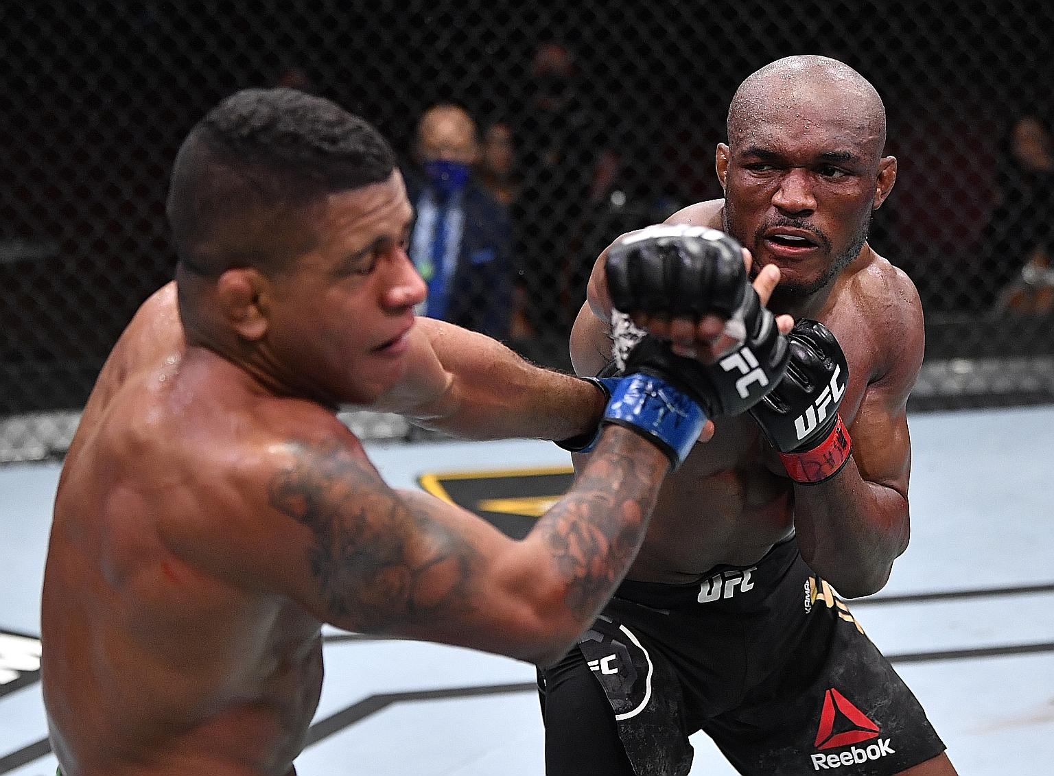 Kamaru Usman punching Gilbert Burns during their UFC welterweight championship fight at UFC 258 in Las Vegas on Saturday.