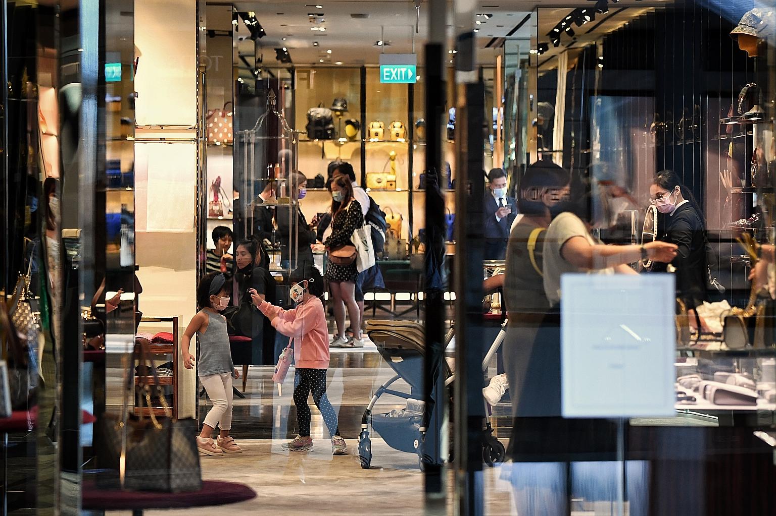 Shoppers at Marina Bay Sands yesterday. Deputy Prime Minister Heng Swee Keat said the GST hike will happen "sooner rather than later". ST PHOTO: KUA CHEE SIONG