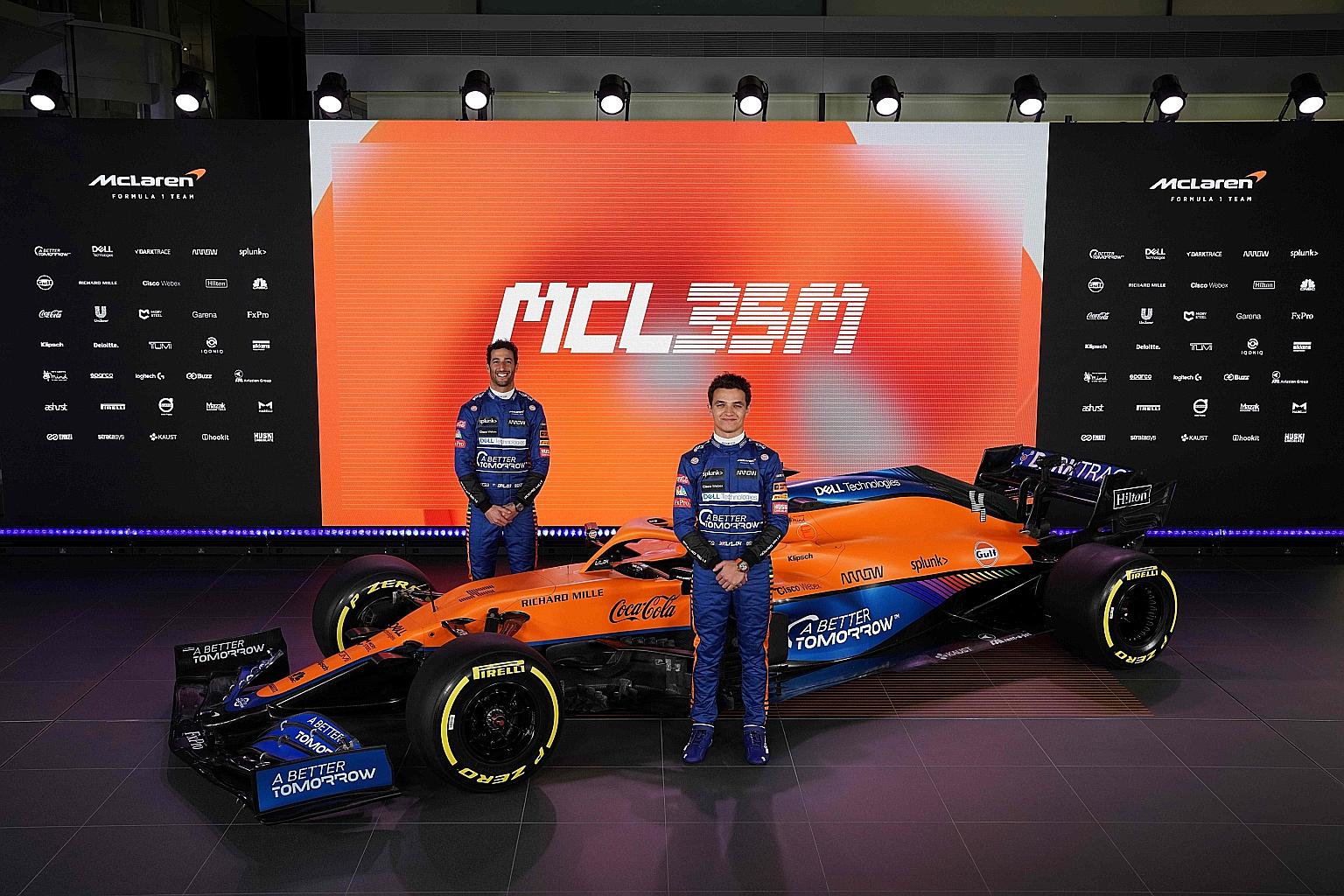 McLaren's Lando Norris (front) and Daniel Ricciardo posing by the team's new MCL35M car in Woking. Ricciardo will race for the British outfit this coming season following his departure from Renault.