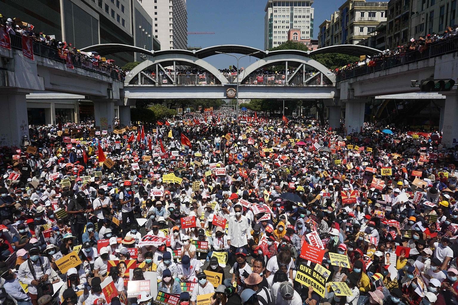 Protesters in Yangon blocking a major road during yesterday's rally against the military coup. Tens of thousands also took to the streets in Mandalay - the second-largest city in Myanmar after Yangon - where some people blocked its main rail link, an