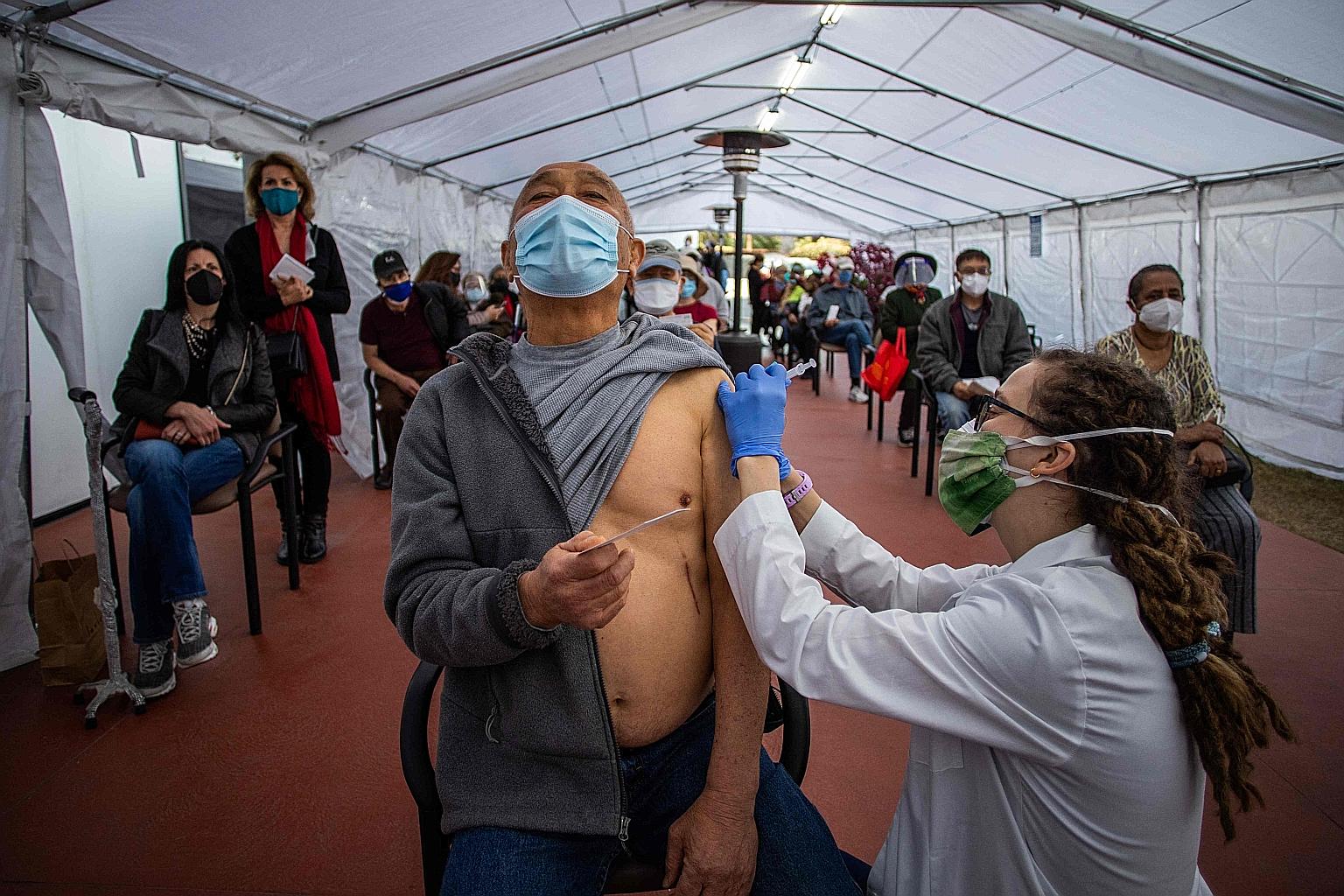 People waiting for their turn to be inoculated in Los Angeles. The vaccination roll-out in the US has been hit by storms that blanketed much of the nation in snow and ice. Communities are now uncertain when the next doses will arrive and appointments