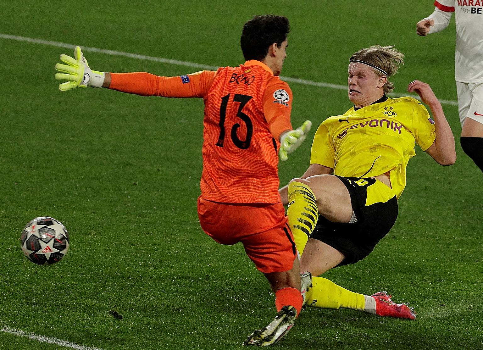 Erling Haaland scoring past Bono to give Dortmund the lead against Sevilla. His double has boosted his tally to 18 goals in 13 Champions League matches.