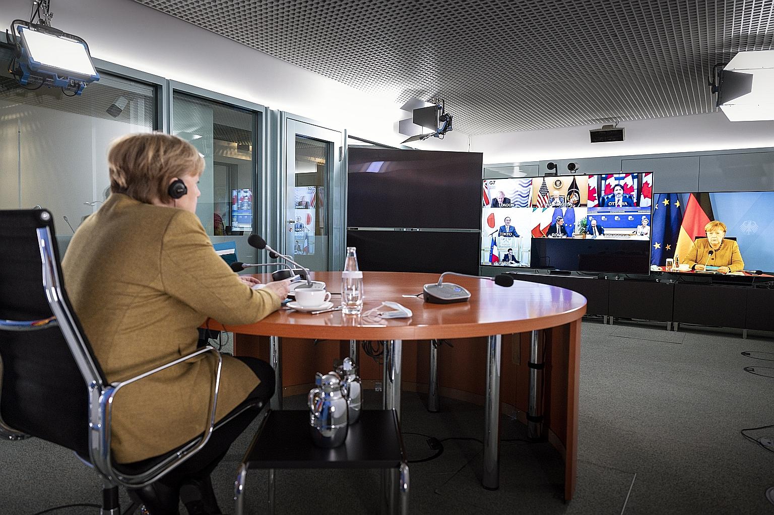 German Chancellor Angela Merkel in Berlin on Friday, taking part in a Group of Seven virtual meeting. After she interrupted British Prime Minister Boris Johnson, he said: "Can you hear us, Angela? I think you need to mute."