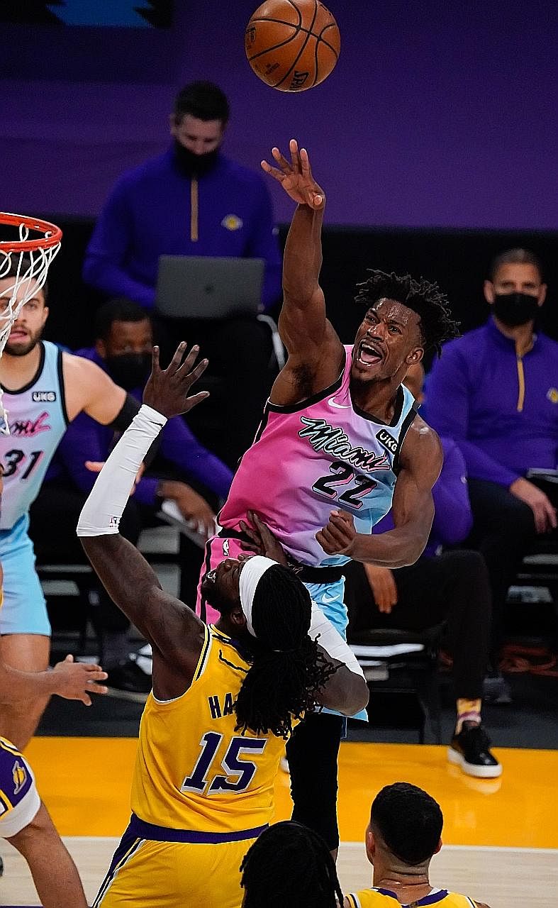 Heat forward Jimmy Butler shooting over Lakers centre Montrezl Harrell during their NBA clash at Staples Centre on Saturday. Butler, who made two clutch free throws with 12 seconds left, finished with 24 points.