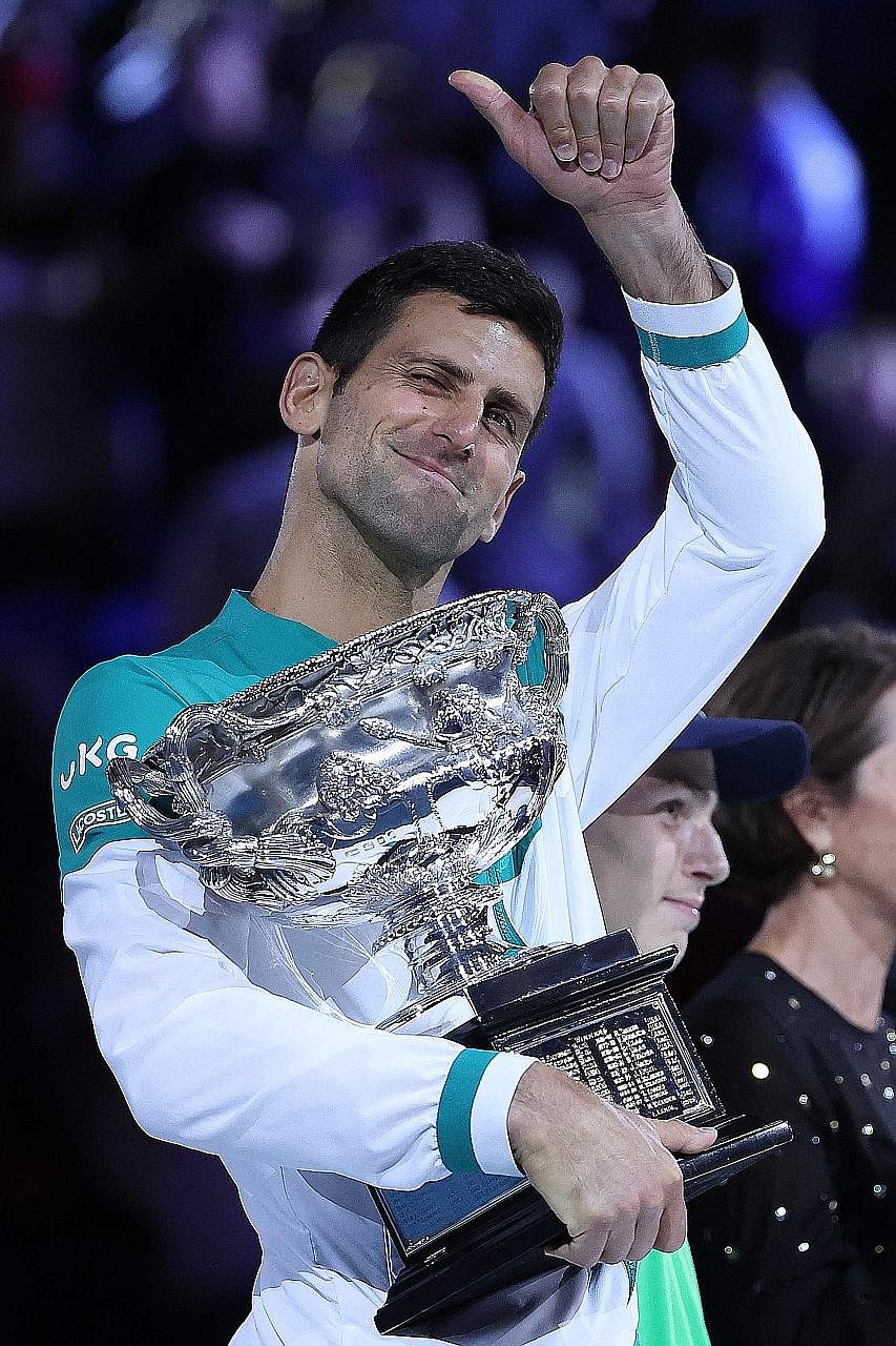 Novak Djokovic holding the Norman Brookes Challenge Cup again after demolishing Daniil Medvedev in 113 minutes. He broke the Russian seven times and hit 20 winners to 17 unforced errors.