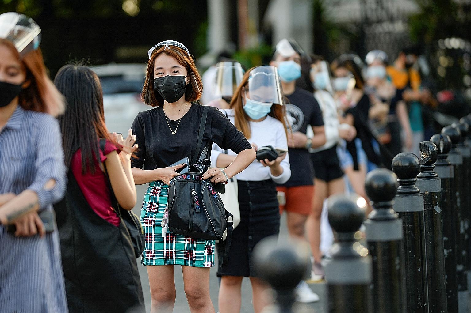 People wearing face masks and face shields in Manila, amid the coronavirus outbreak, last Thursday. A task force overseeing the Philippine government's Covid-19 efforts had advised President Rodrigo Duterte to further ease quarantine curbs to revive