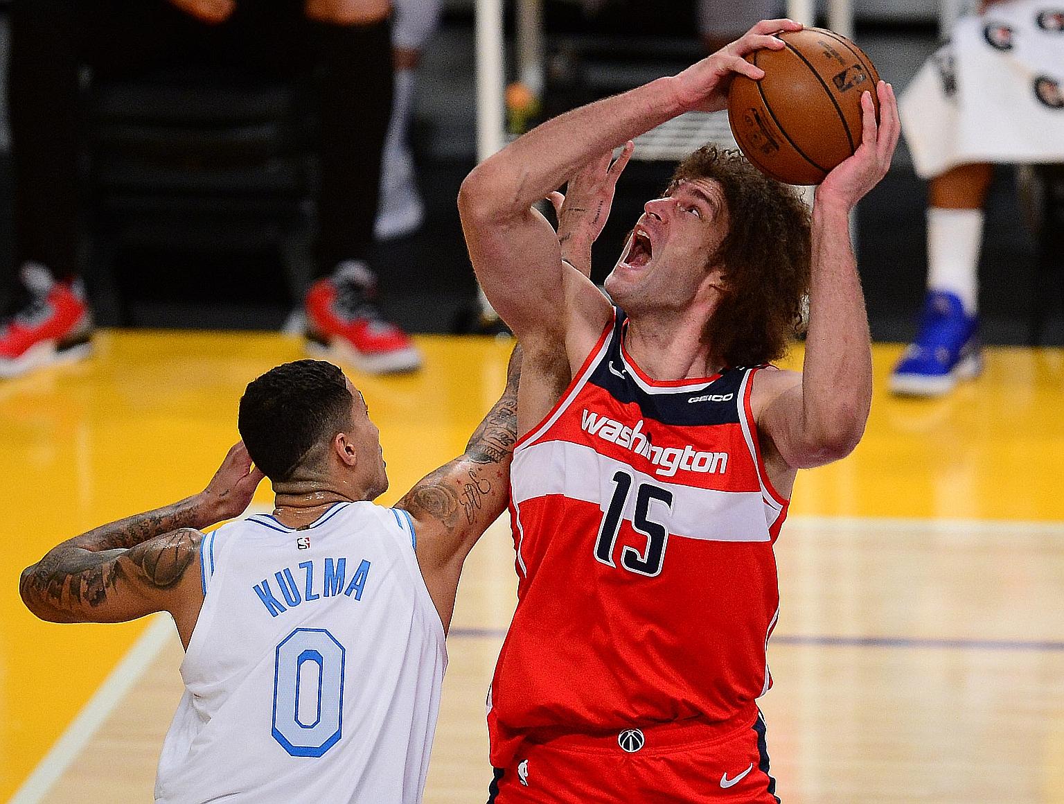 Wizards centre Robin Lopez goes for a basket but is blocked by Lakers forward Kyle Kuzma during their game, which the visitors won 127-124 after overtime.