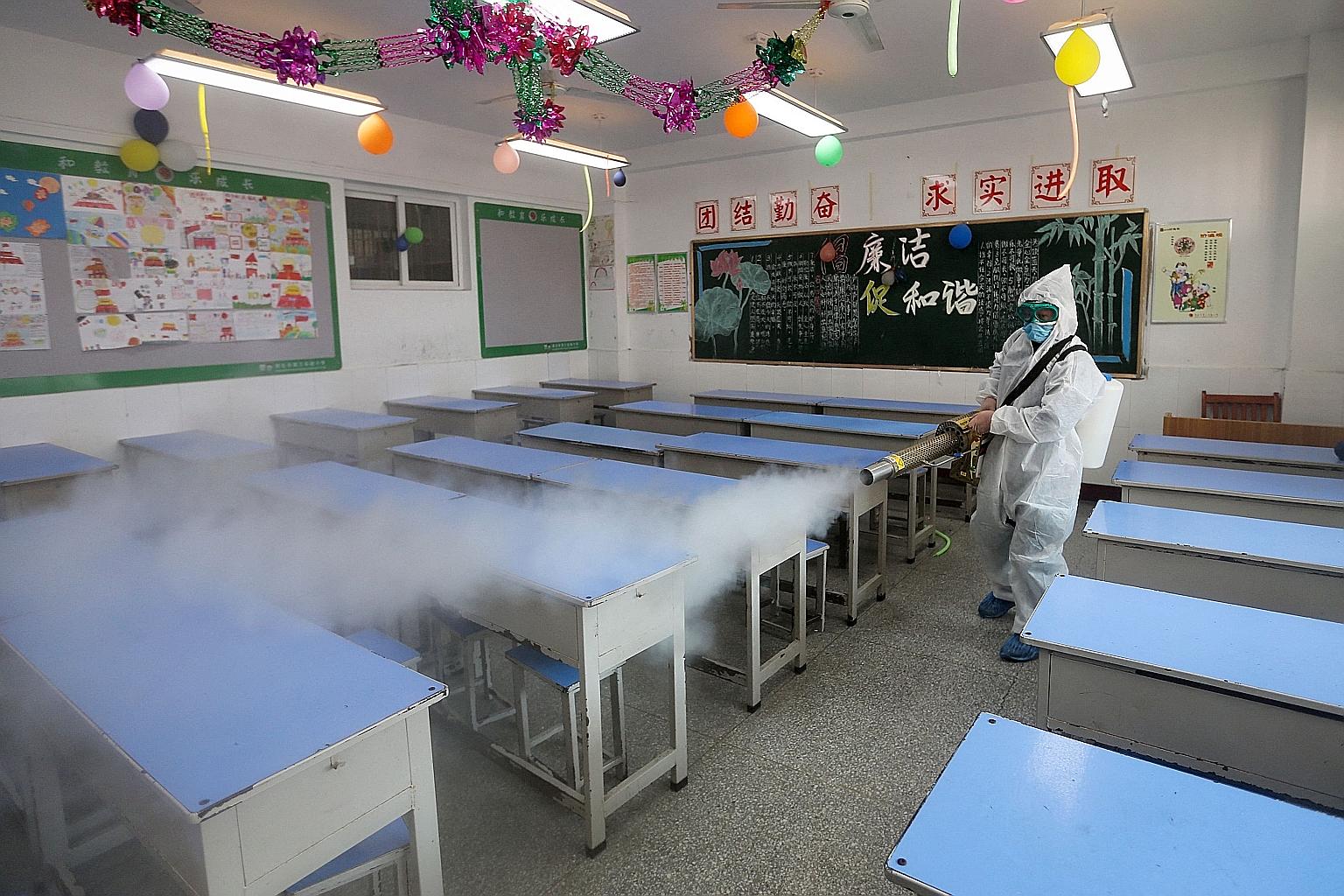 A worker spraying disinfectant in a primary school in Huaibei, Anhui province, on Feb 19 ahead of the start of a new term. The Covid-19 pandemic and the disrupted academic schedules are making millions of Chinese parents shell out money to ensure the