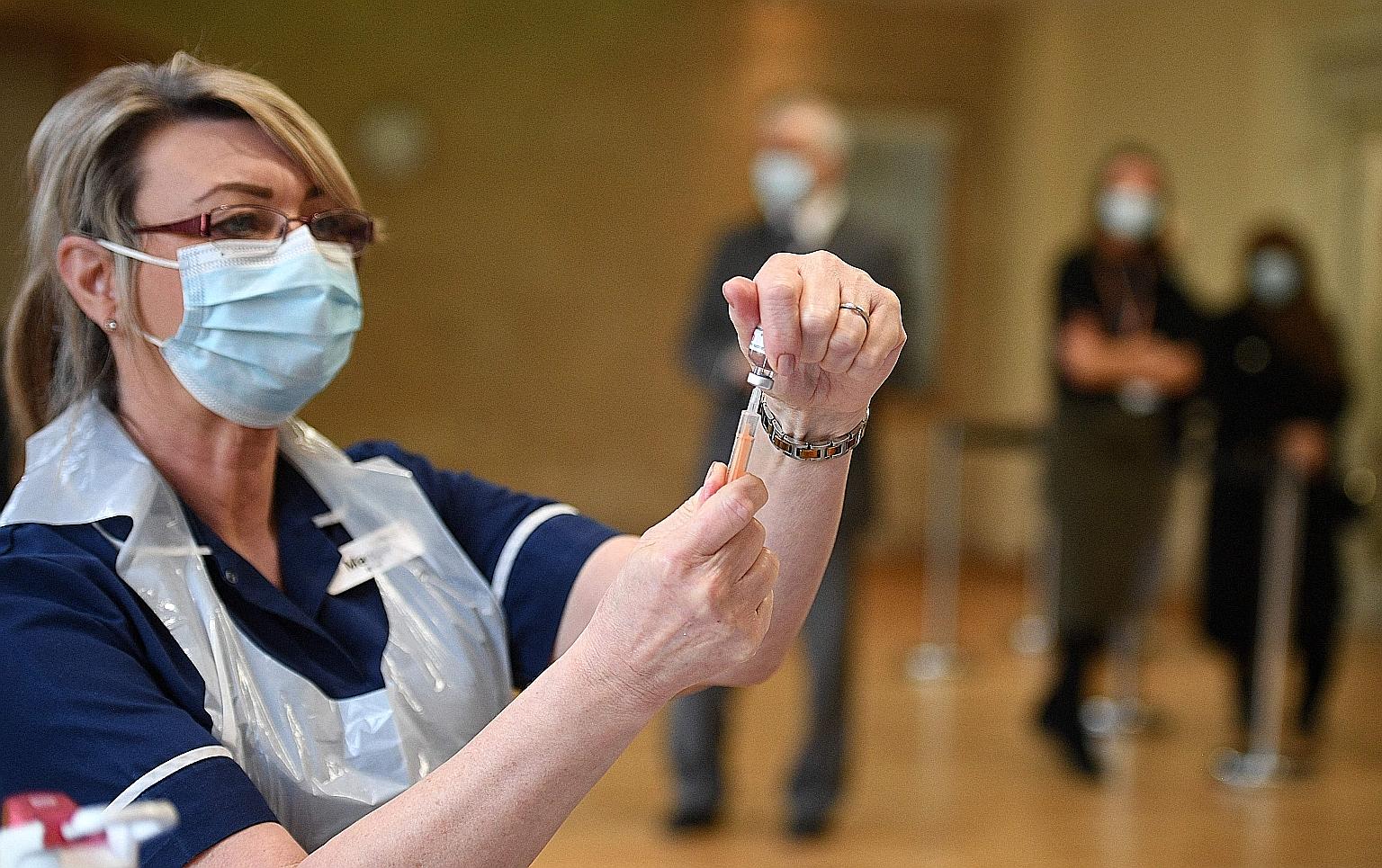 A nurse preparing a dose of the AstraZeneca vaccine at a vaccination centre in Nottingham, England. No other large country is inoculating people as quickly as Britain, which was the first country in the world to authorise and begin using both the Pfi