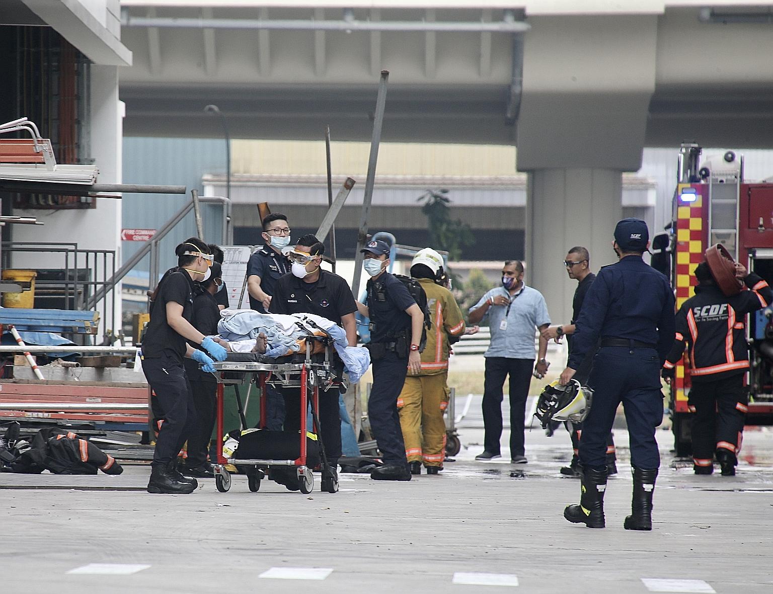 Officers from the Singapore Civil Defence Force (SCDF) tending to a worker who was injured in an explosion in an industrial building in Tuas yesterday. Ten people were taken to hospital following the blast, which occurred just after 11am on the premi