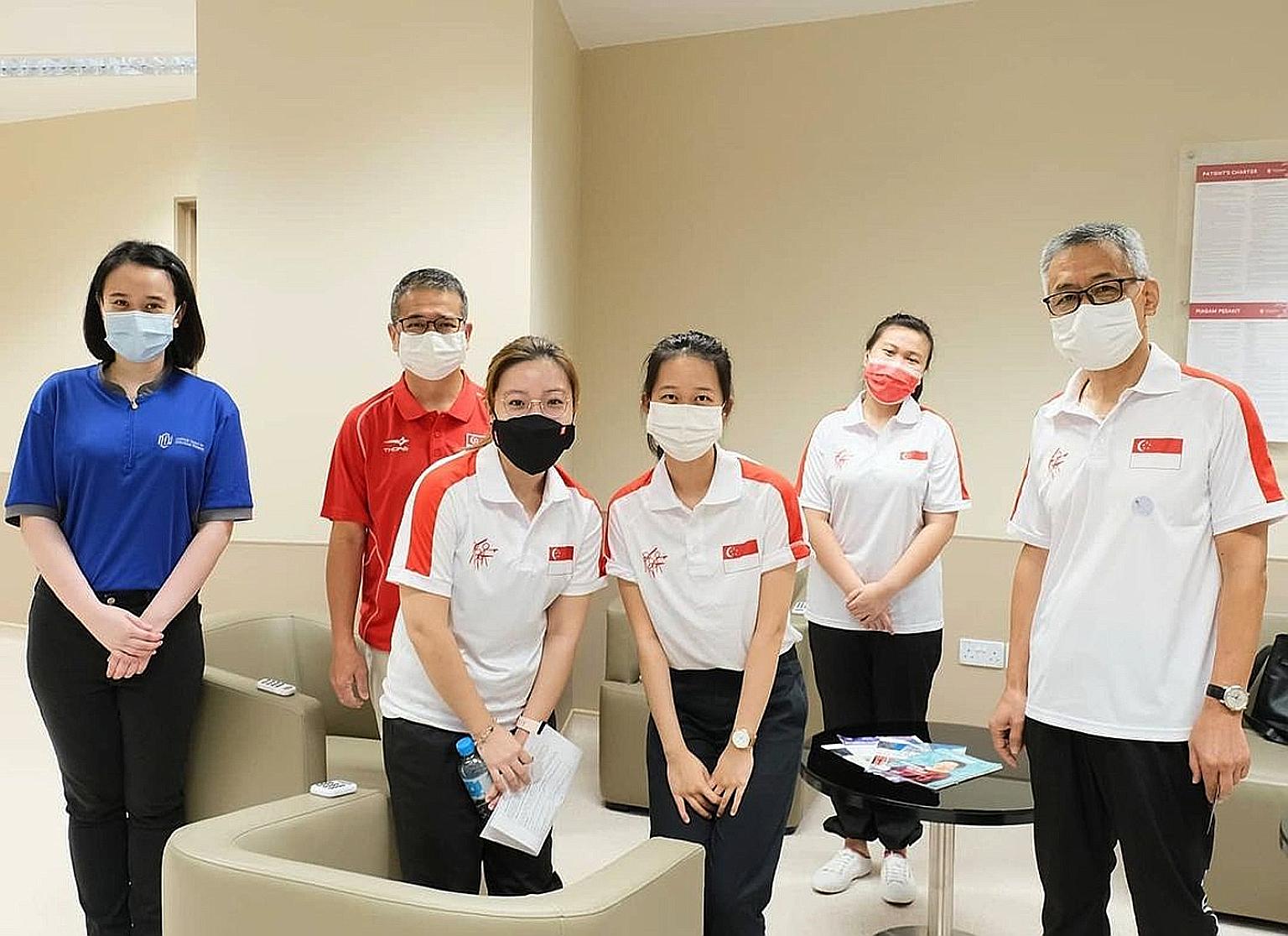 (From left) NCID senior staff nurse Alicia Chua, Minister for Culture, Community and Youth Edwin Tong, Team Singapore shooters Adele Tan, Tessa Neo and Ho Xiu Yi, and their coach Song Haiping at the centre on Wednesday.