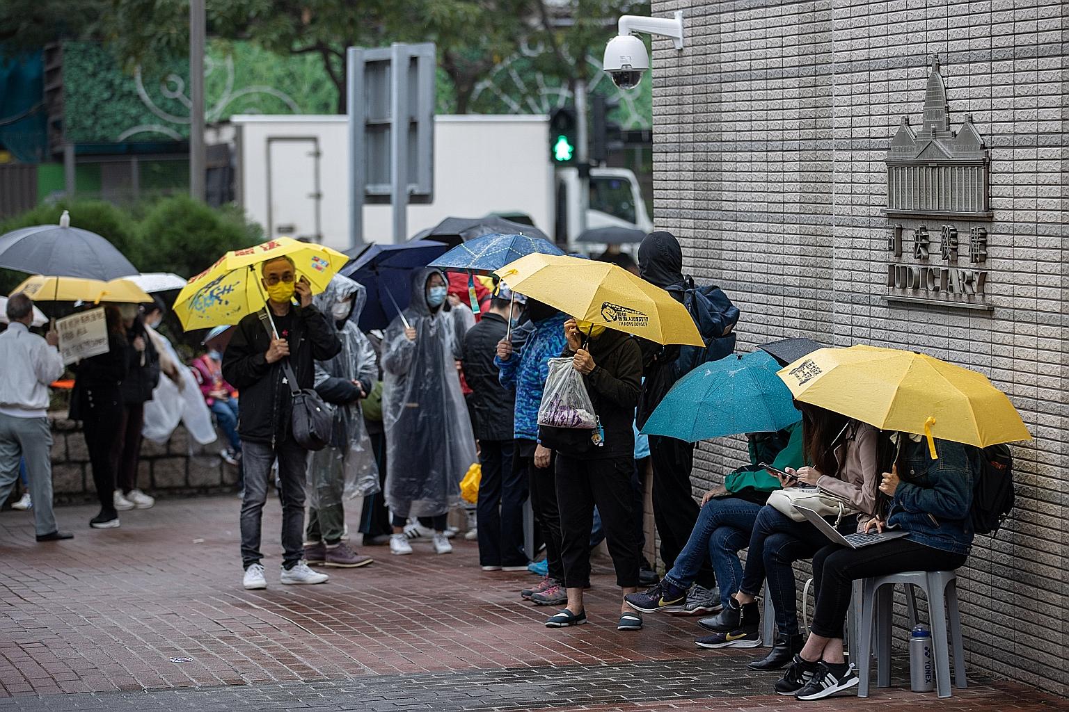 Pro-democracy supporters outside the West Kowloon court building in Hong Kong yesterday, as a bail hearing for 47 activists charged with conspiracy to commit subversion entered its fourth day.
