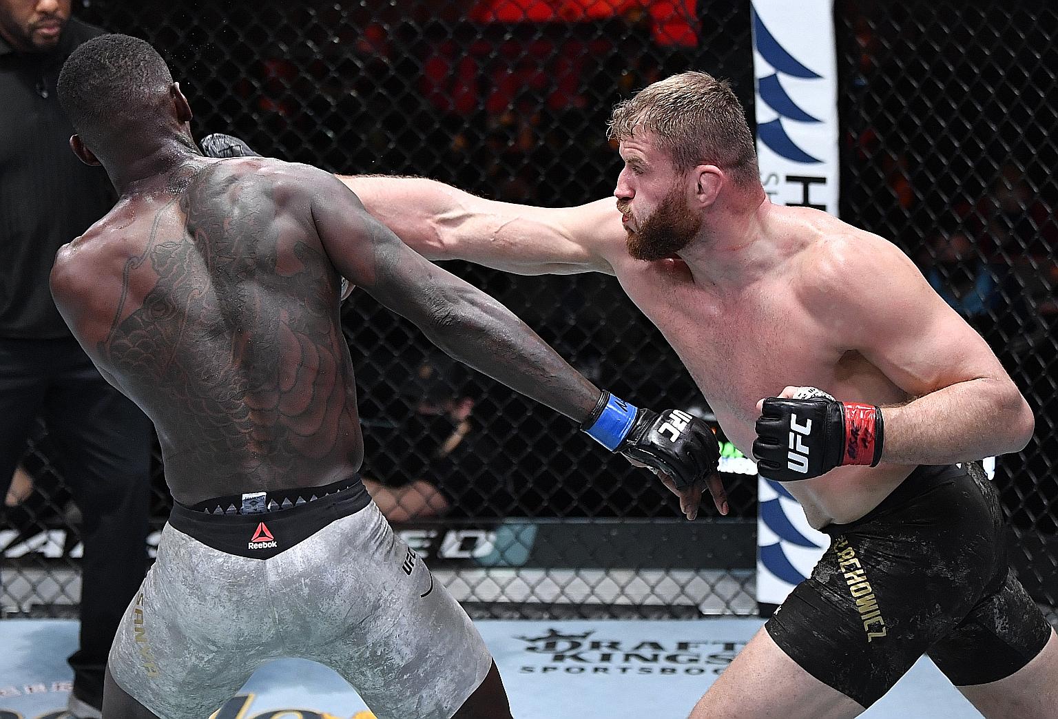 Jan Blachowicz of Poland punching New Zealand's Israel Adesanya in their UFC light heavyweight championship fight at UFC 259 yesterday. Blachowicz won via a unanimous decision of 49-46, 49-45 and 49-45.
