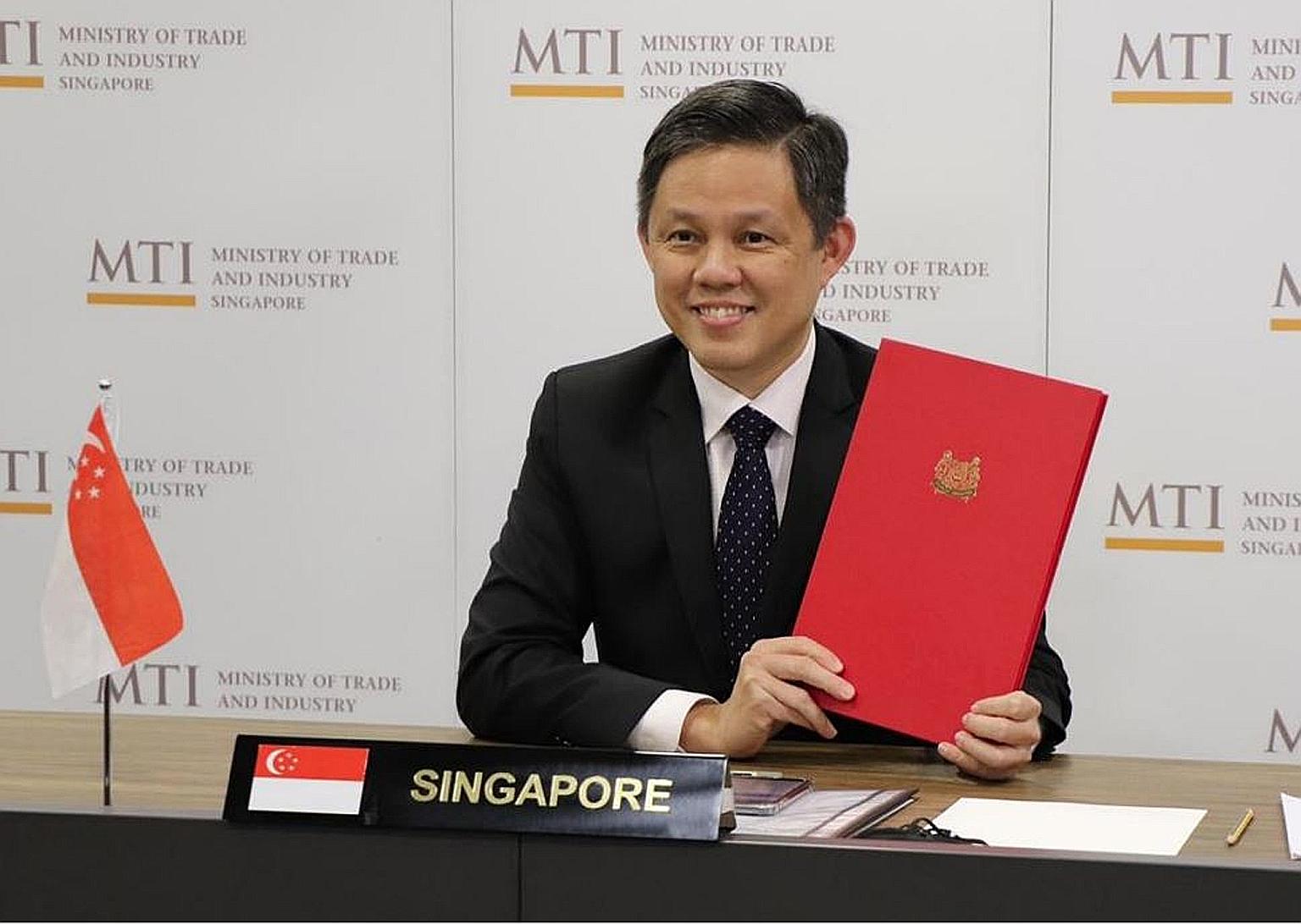 Singapore Minister for Trade and Industry Chan Chun Sing with the ratification document yesterday, when the bilateral investment treaty with Indonesia was ratified in a virtual meeting between the two sides.