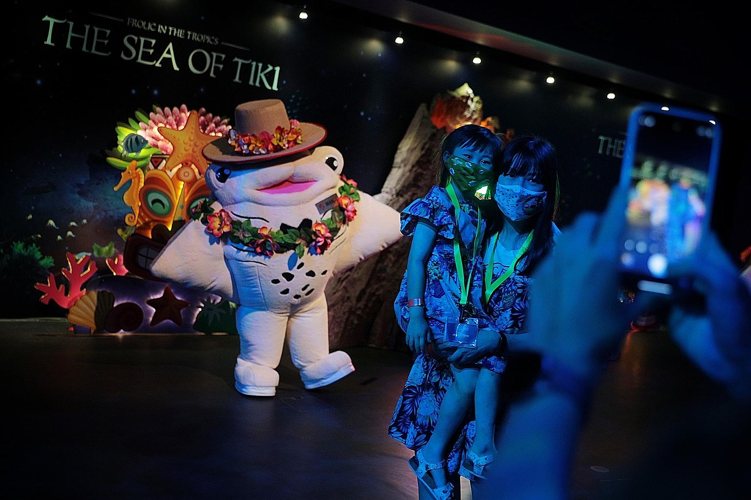 Guests posing with mascot Manja at the S.E.A. Aquarium in Sentosa yesterday. The aquarium's three mascots - Manja, Mika, and Mako - will be wearing tropical costumes as part of the attraction's new theme.