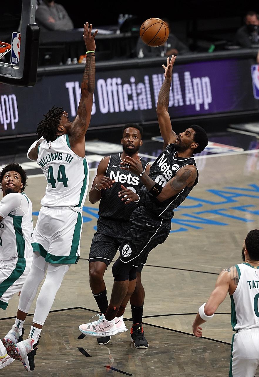 Nets guard Kyrie Irving taking a shot as Boston centre Robert Williams III defends at Barclays Centre in New York. His team were missing Kevin Durant for a 10th straight game while James Harden finished with 22 points.