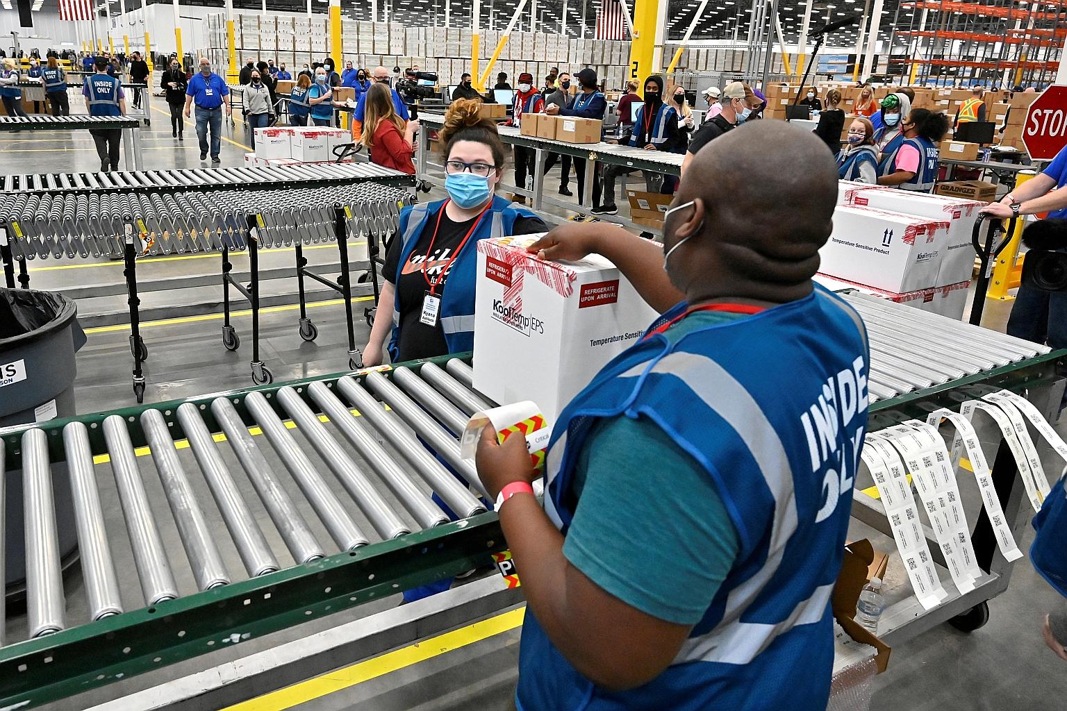 A box containing vials of Johnson & Johnson's Covid-19 vaccine being moved along a conveyor belt towards a transport truck at the McKesson facility in Shepherdsville, Kentucky, on March 1. The shot received approval from the European Union on Thursda