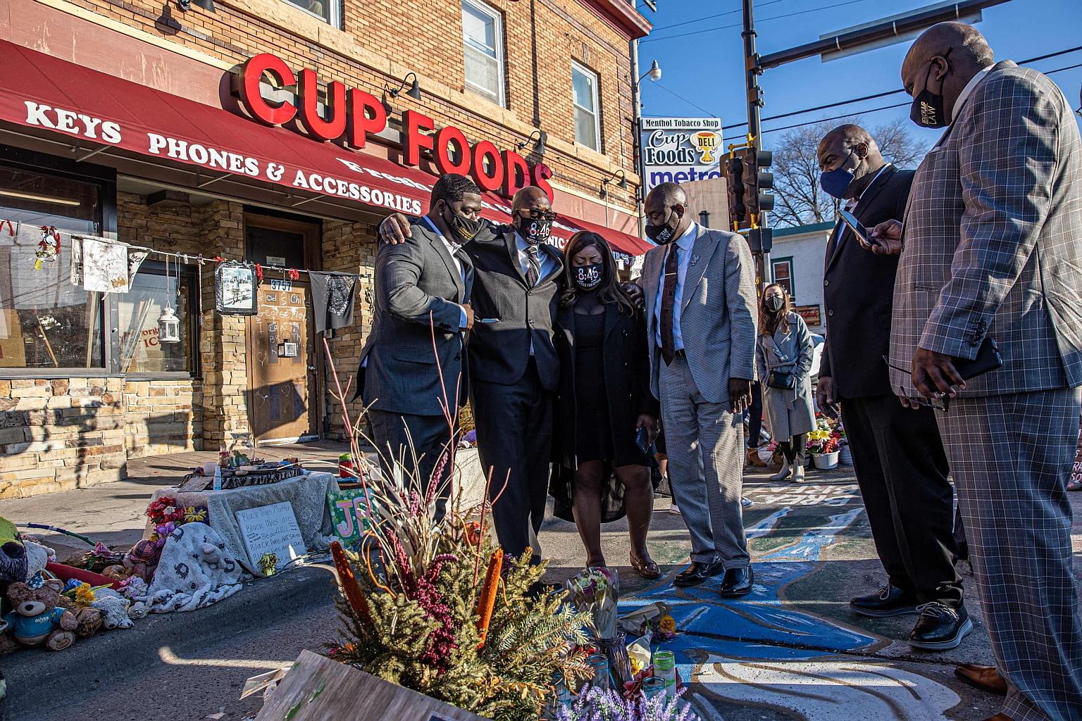 Left: Members of Mr George Floyd's family with one of their attorneys, Mr Ben Crump (fourth from left), visiting a memorial on Friday at the site where he died last year. The payment to settle the family's lawsuit is among the largest of its kind. Ri