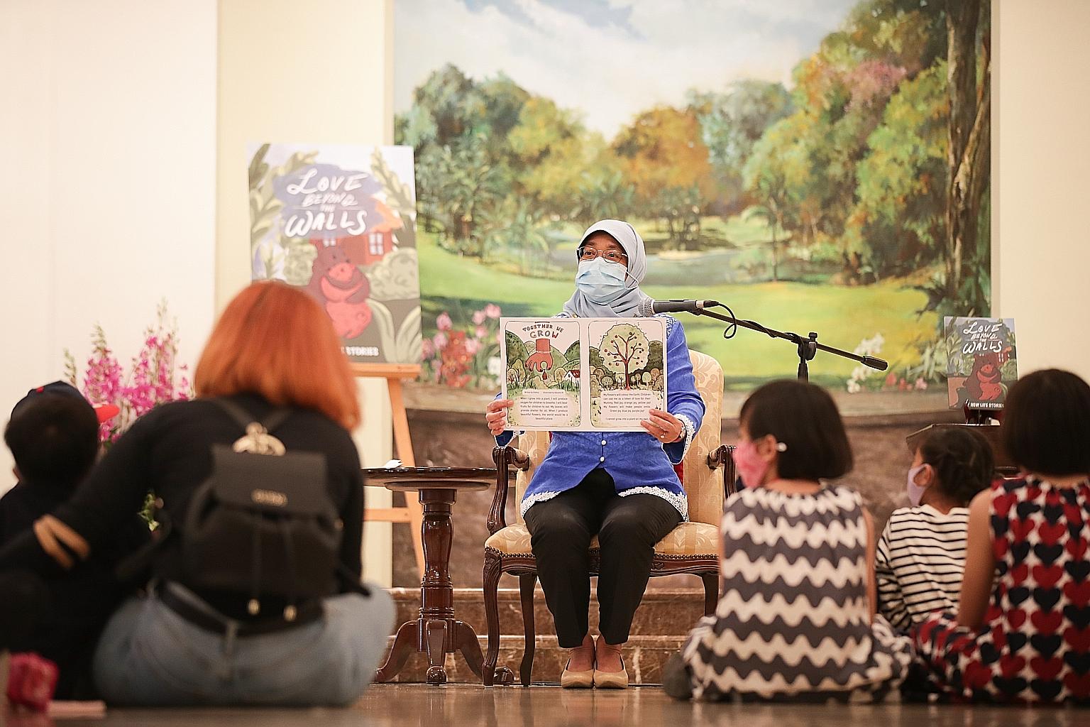 President Halimah Yacob reading Together We Grow, a story from Love Beyond The Walls, an anthology of stories written by mothers who were previously incarcerated, during the Garden Tour @ Istana event yesterday. PHOTO: LIANHE ZAOBAO