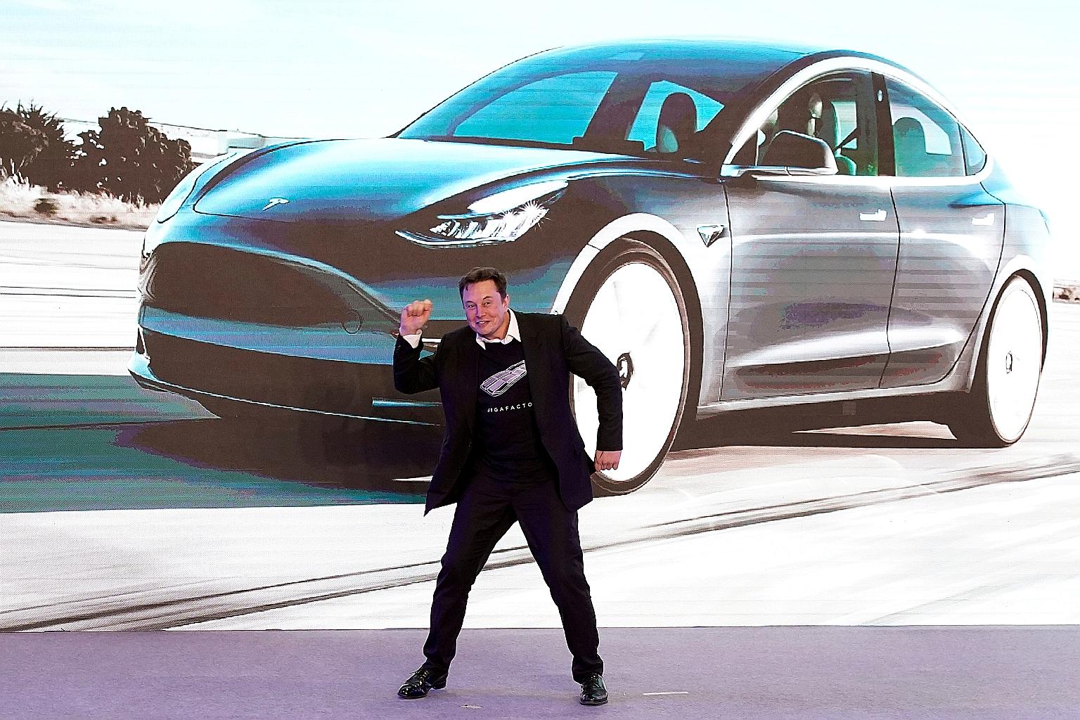 Tesla chief executive Elon Musk dancing on stage during a delivery event for the company's China-made Model 3 cars in Shanghai last year. The company, in a first for a foreign carmaker in China, has been allowed to run its plant without a local partn