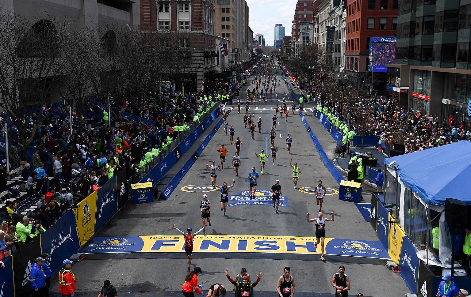 Runners approaching the finish line on Boylston Street during the 123rd Boston Marathon in April 2019. This year's field is about a third smaller.