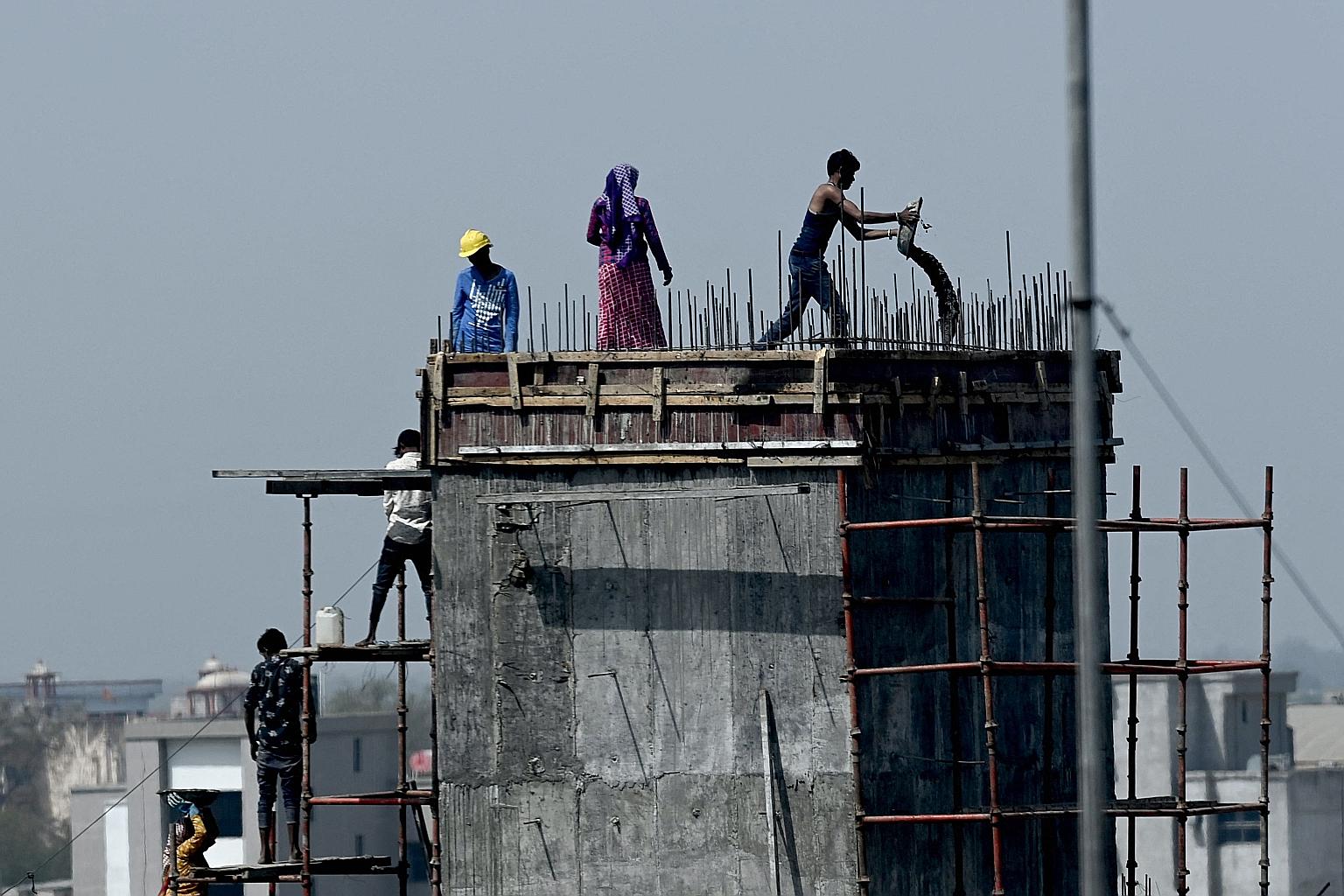 Workers at a construction site in Ahmedabad. Moody's Analytics forecasts India to record the strongest growth of 12 per cent, followed by China (8.3 per cent) and Vietnam (7.5 per cent) in Asia-Pacific. PHOTO: AGENCE FRANCE-PRESSE