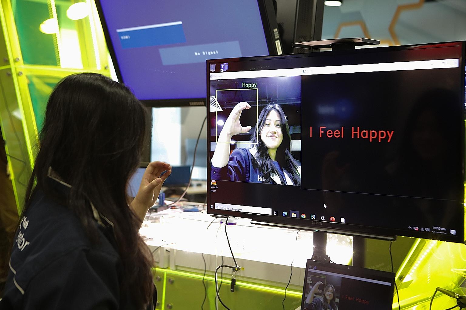 A Higher Nitec student at ITE College West demonstrating her smart artificial intelligence (AI) sign language software in a showcase of social impact AI projects, at the launch of the AI For Citizens online micro-learning course yesterday. PHOTO: LIA