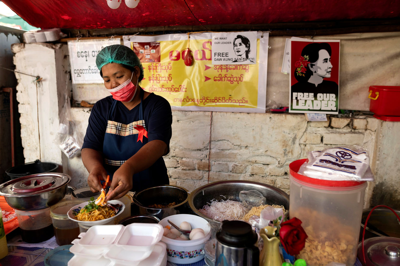 A woman cooking at a food stall in Yangon last month. The World Food Programme said food and fuel prices have been rising in Myanmar since the Feb 1 military coup, raising concern about the ability of the poor to feed themselves. PHOTO: REUTERS