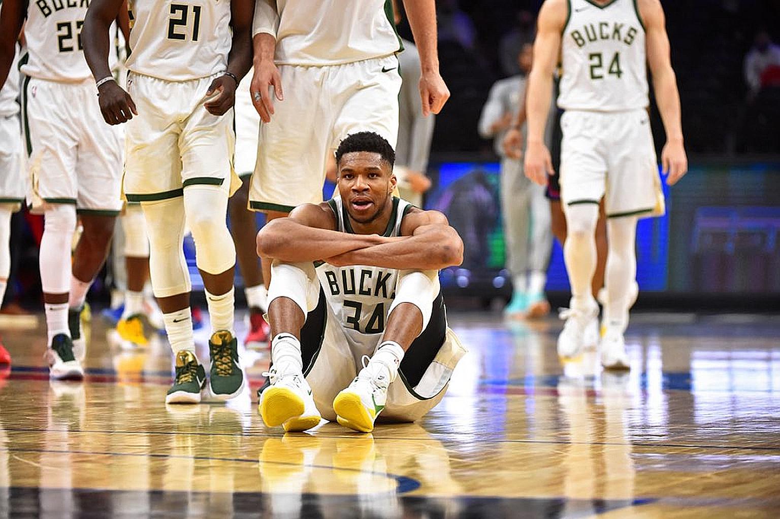 Giannis Antetokounmpo with his sit-down celebration after passing Sixers guard Ben Simmons, attacking the paint, crossing his marker, and scoring to give the Bucks a 105-98 lead.