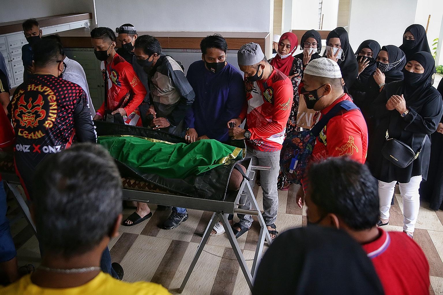 Friends and relatives carrying Putera Muhammad Indra Shazrine Suzaini's body back to his family flat in Yishun on Aug 23 last year. The 14-year-old's (above) body was found in the waters off Changi Beach Park the day before. ST PHOTO: KEVIN LIM
