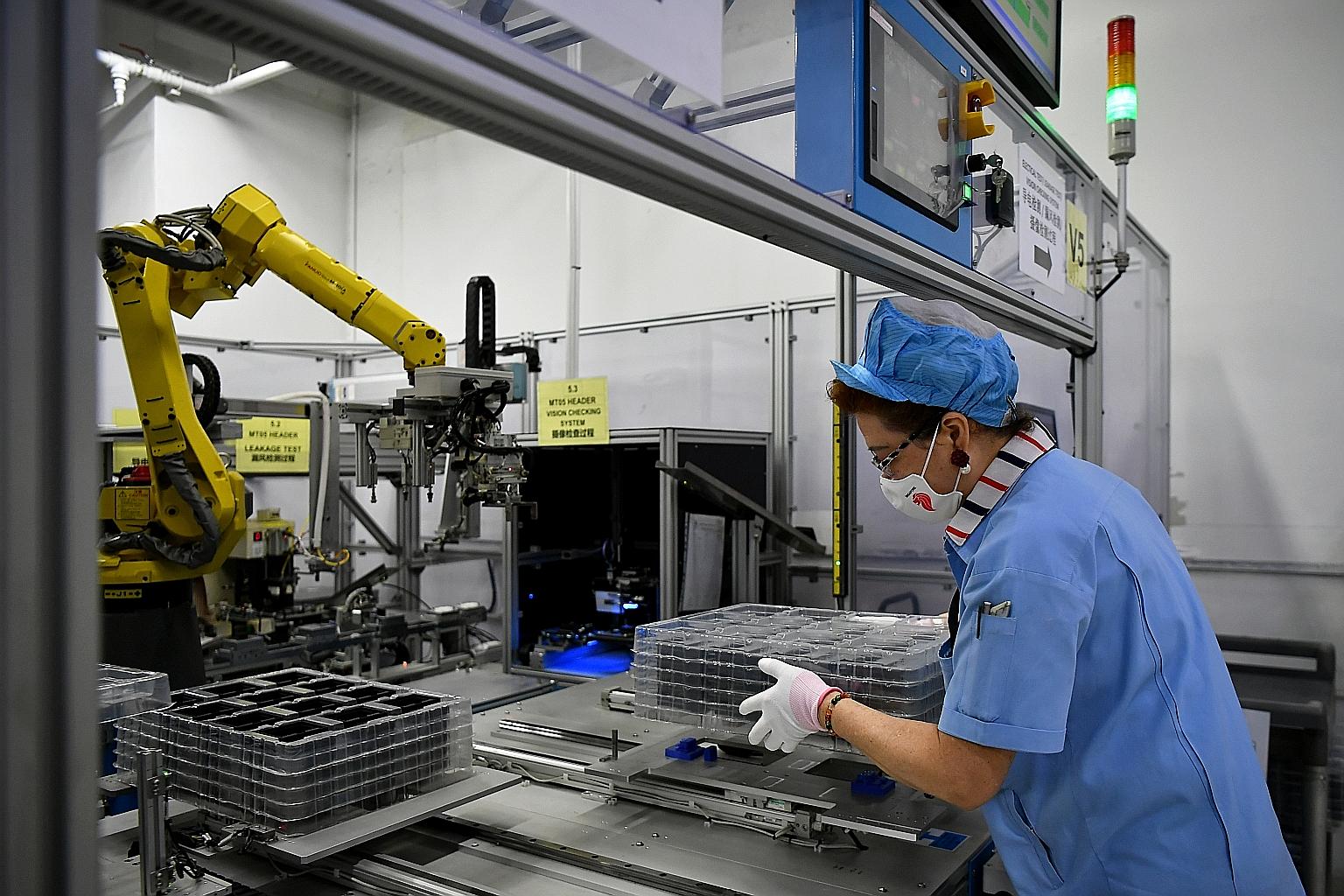 Jiejie Semiconductor Company employees at work in a factory in Nantong, in eastern China's Jiangsu province. China's shift into higher-value manufacturing, including semiconductors and components, has eroded the global market share of producers here,