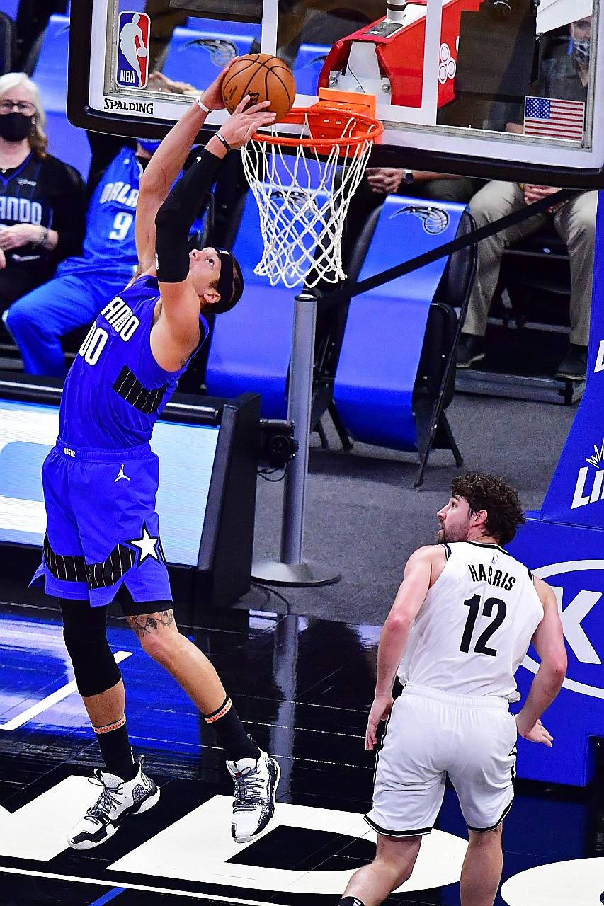 Orlando's Aaron Gordon dunking over Brooklyn's Joe Harris on Friday. Gordon shot 14 of 20 from the field and made seven of eight three-point attempts as the Magic halted their longest skid since December 2017.