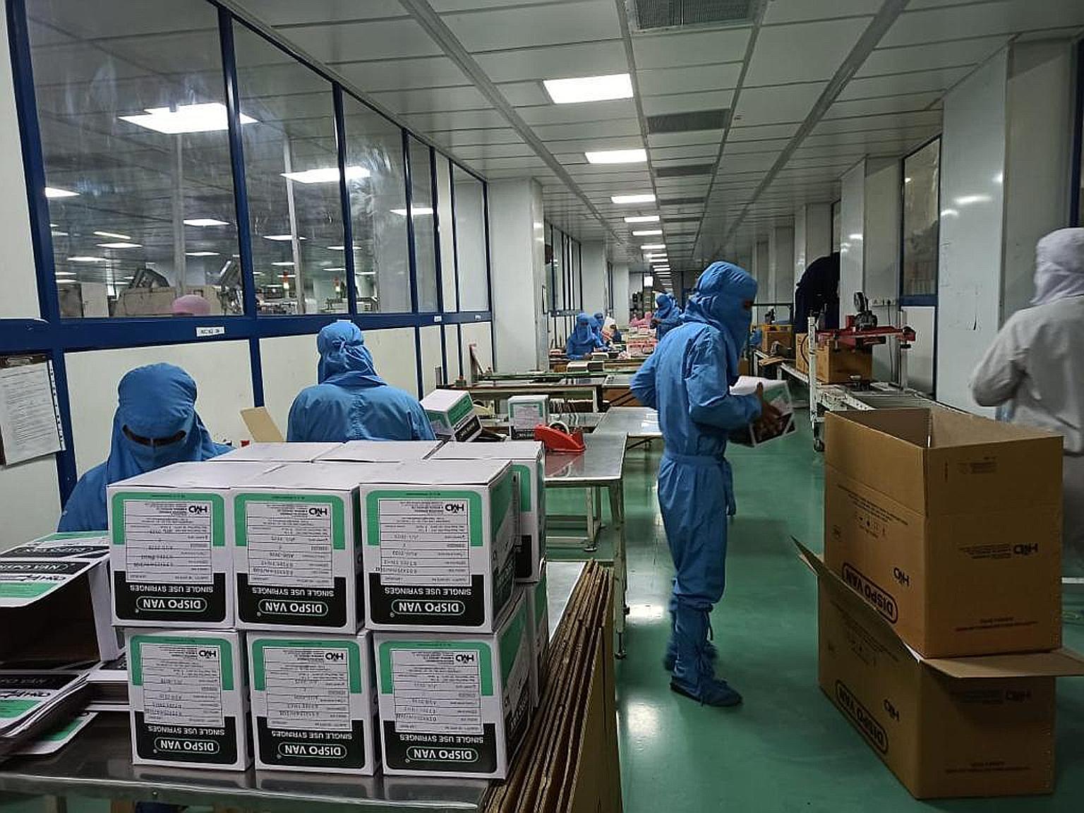 Workers at a Hindustan Syringes & Medical Devices factory in Faridabad, near Delhi. One of the top two global manufacturers of auto-disable syringes, HMD's units today produce more than 375,000 syringes per hour.