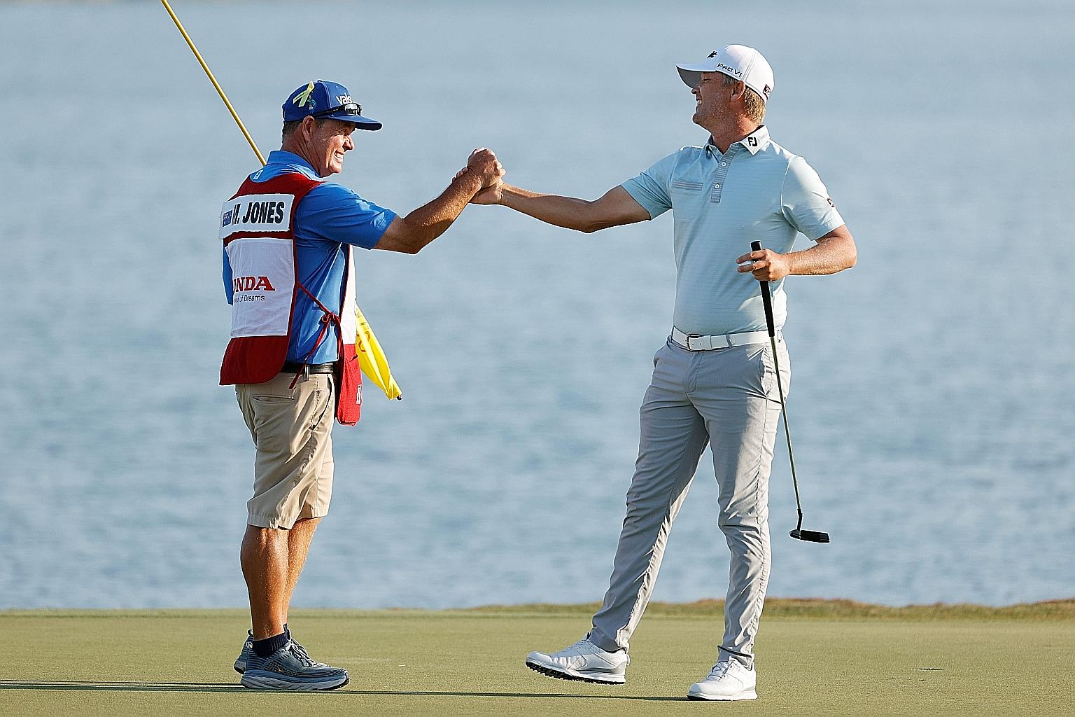 Matt Jones of Australia celebrating with caddie Lance Bailey after winning the Honda Classic in Palm Beach Gardens, Florida.