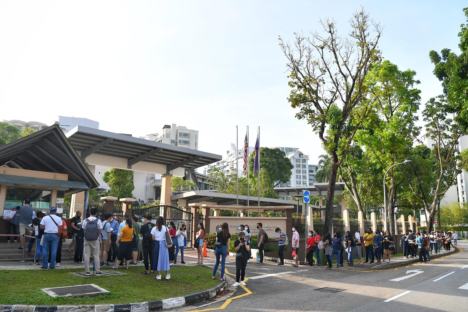 Long queues outside the High Commission of Malaysia at about 8am last Friday. A sudden move not to accept passport renewal walk-ins resulted in over 400 being turned away yesterday morning. ST PHOTO: CHONG JUN LIANG