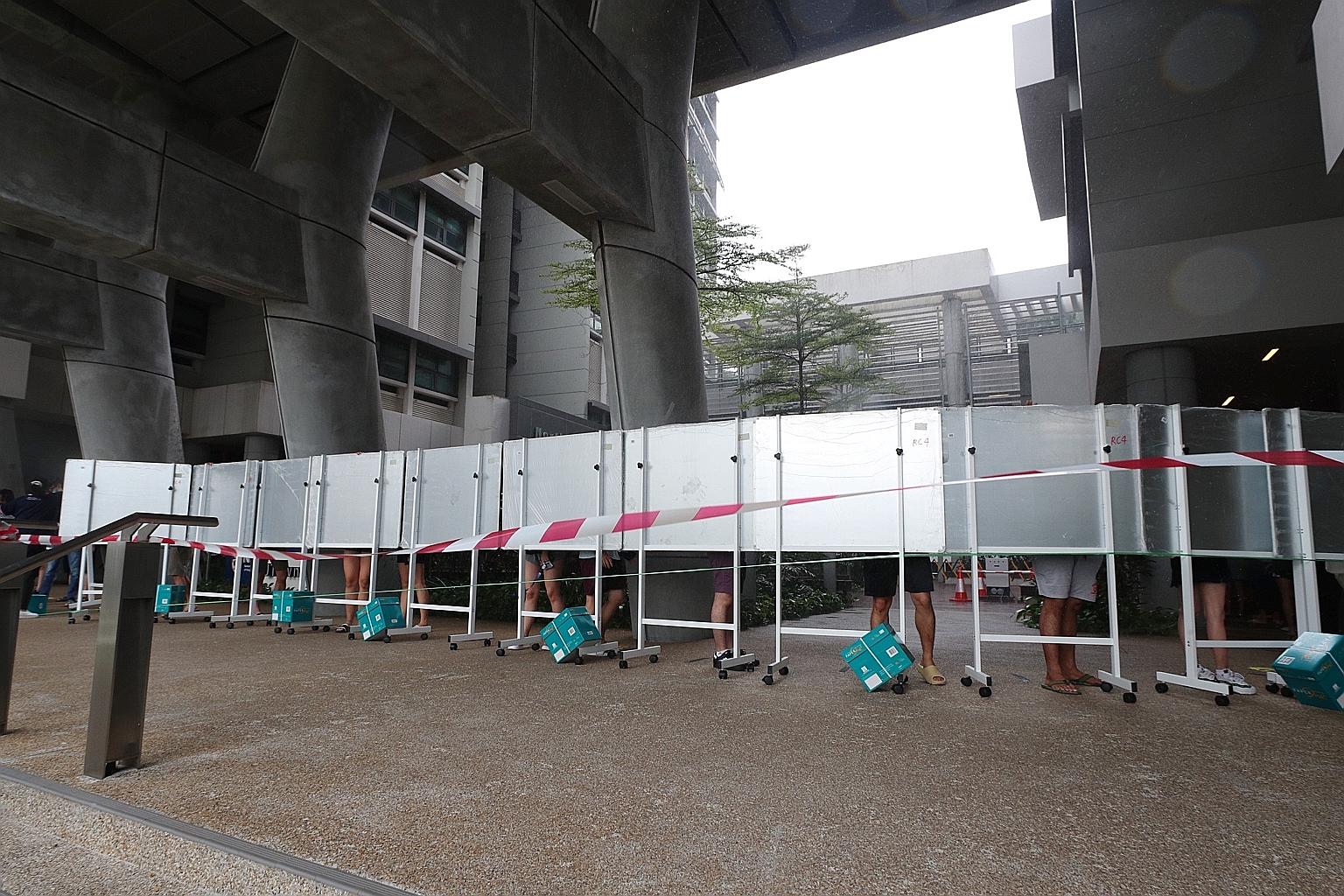 Students queueing to get the polymerase chain reaction swab test at University Town yesterday. Residents of 13 units were told they have to stay indoors until the results are out, which could take two to three days.
