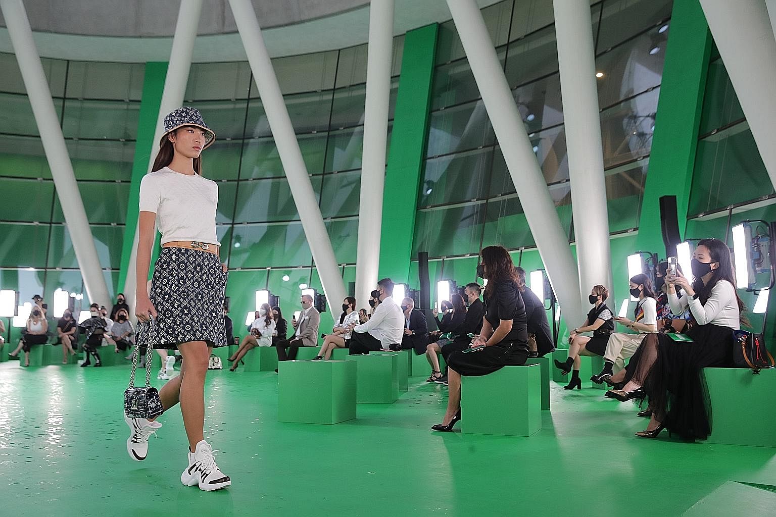 Life returned to the runway yesterday, with the first full-fledged fashion show staged in Singapore since the pandemic began. The ArtScience Museum basement was transformed into an emerald city for the Louis Vuitton show, presented live to 112 guests