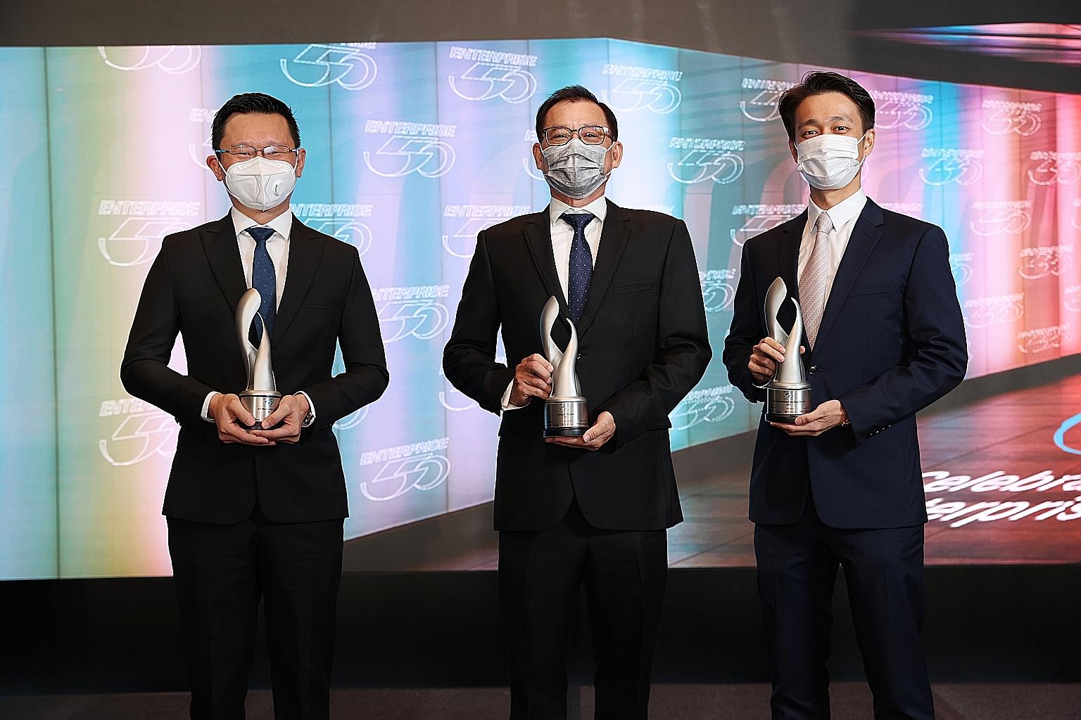 Mr Cheong Beng Wah (centre), chief executive of Raduga - which distributes mobile phones and provides marketing management and logistics solutions - said the company's clinching of the top spot in the 2020 Enterprise 50 Awards was recognition that Ra