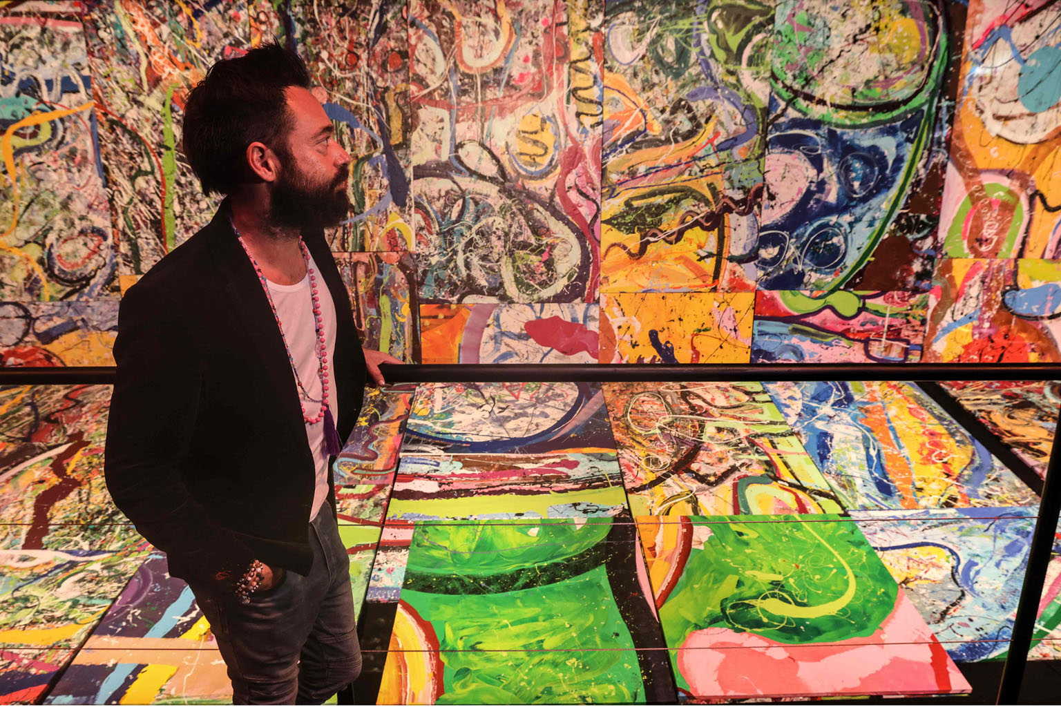British contemporary artist Sacha Jafri with fragments of his painting, titled The Journey of Humanity, in the city of Dubai in the United Arab Emirates last month. The artwork - which holds the Guinness World Record for the largest art canvas - has 