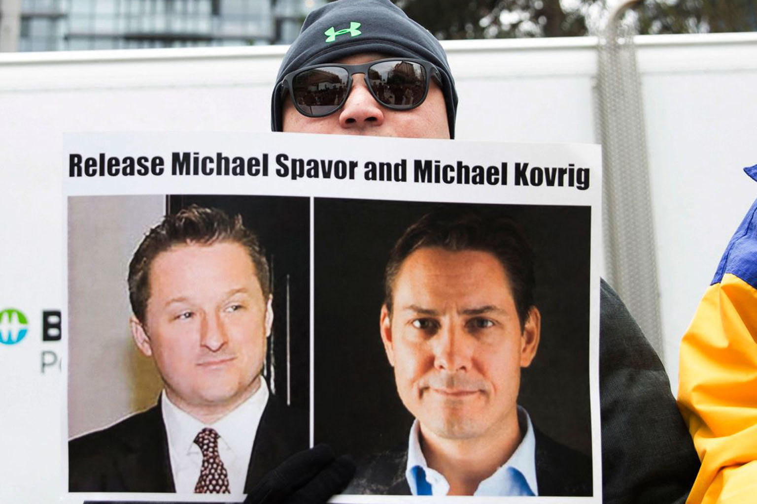 A protester with a poster of Canadians Michael Spavor (left) and Michael Kovrig, who are being held in China, outside the Supreme Court in Vancouver in 2019. Both have been accused of spying.