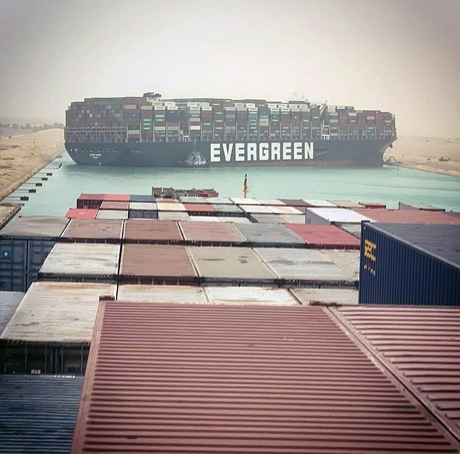A photo of the grounded container ship Ever Given, time-chartered by Taiwan-based Evergreen Line, taken from a vessel stuck behind it. The 400m-long Ever Given's hull became wedged lengthwise across the Suez Canal on Tuesday. PHOTO: EPA-EFE