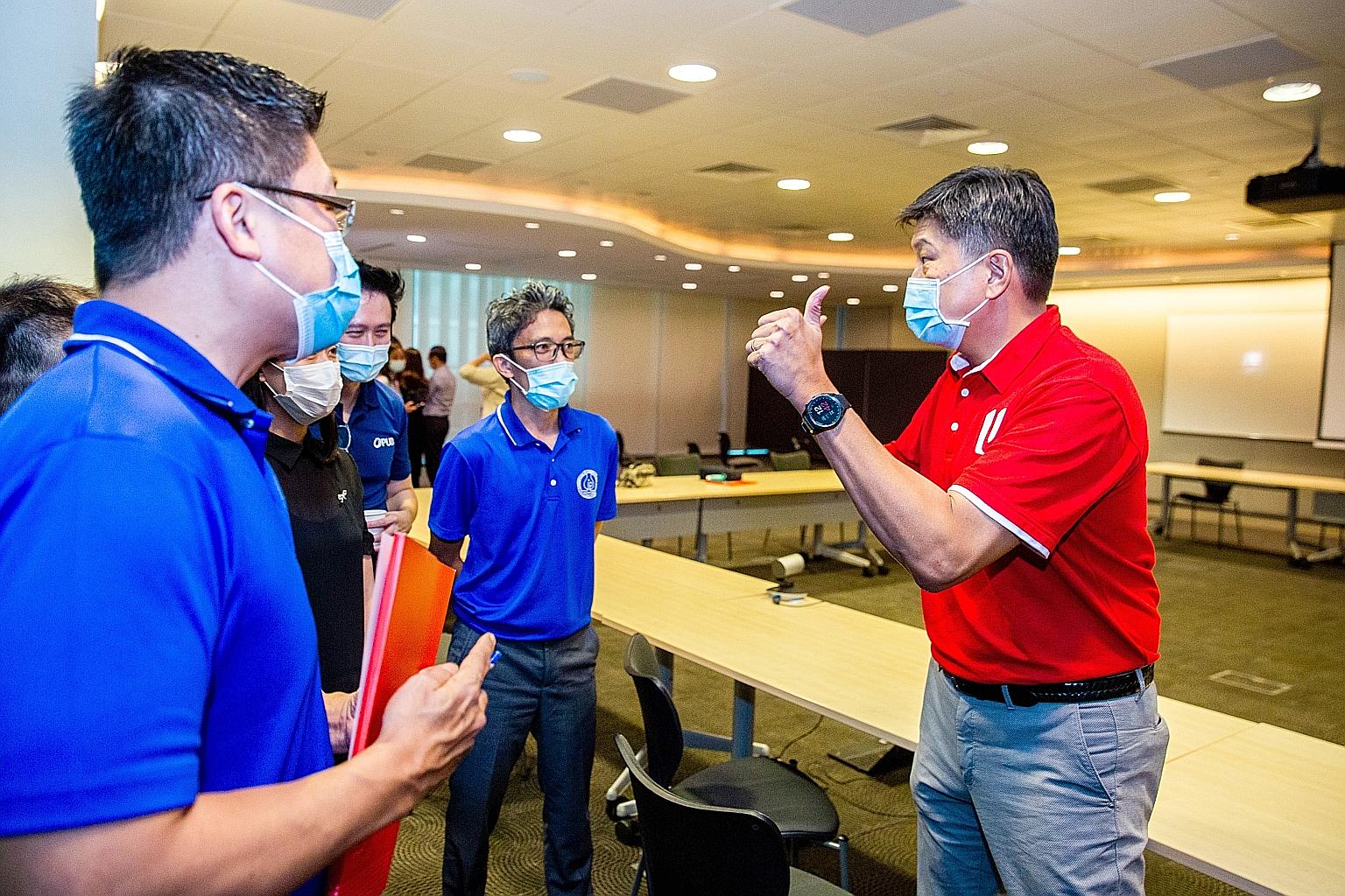 NTUC secretary-general Ng Chee Meng (right) at the NTUC Centre for the signing of an MOU between U SME - the labour union's unit for SMEs - and the Singapore Plumbing Society as well as seven SMEs. PHOTO: NTUC