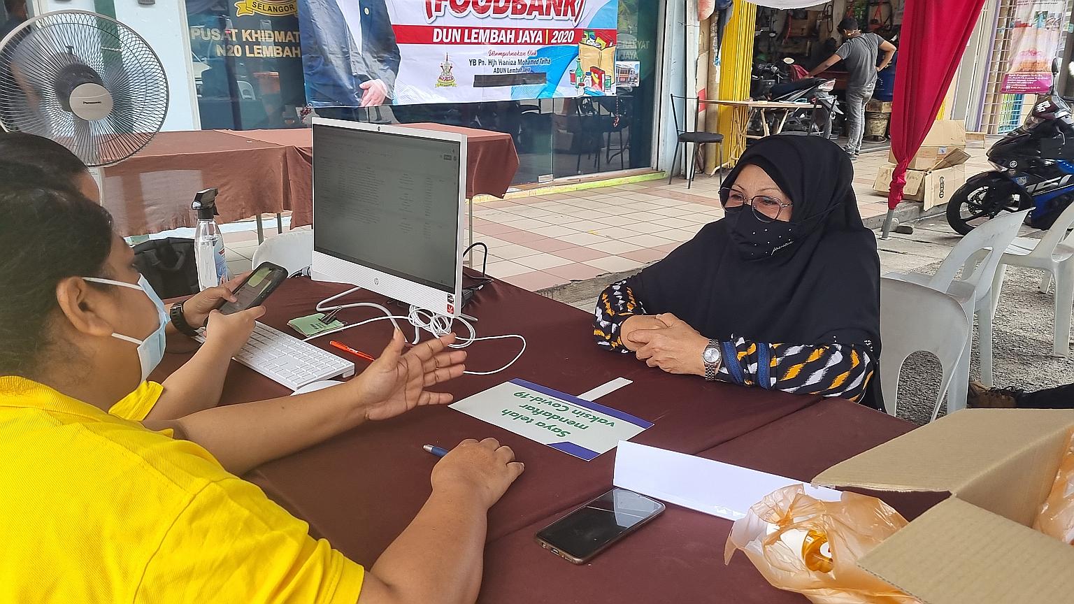 Selangor resident Salfiah Demin, 77, registering for vaccination. She says more registration drives are necessary to help senior citizens receive the free vaccines.