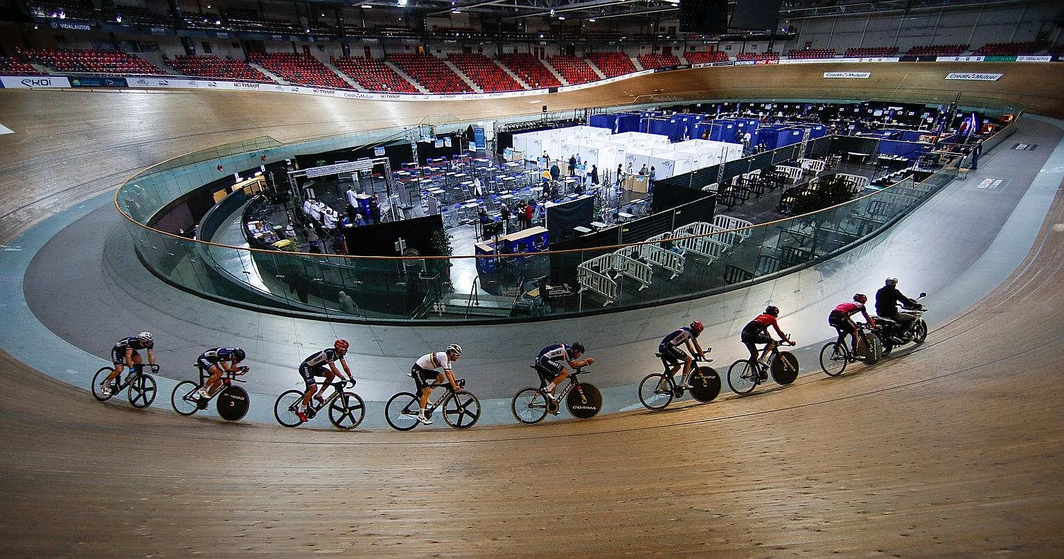 France's national cycling team in training as people received a dose of the Pfizer-BioNTech coronavirus vaccine as part of an inoculation campaign at the indoor Velodrome National of Saint-Quentin-en-Yvelines in Montigny-le-Bretonneux on Friday.
