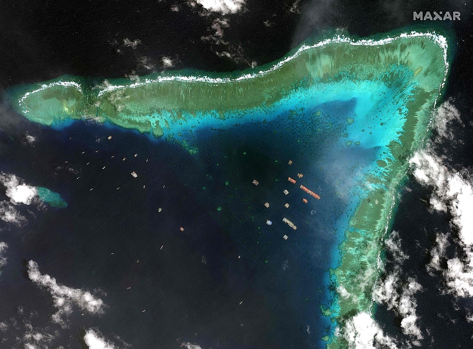 A satellite image taken last Tuesday that shows Chinese vessels anchored at the Whitsun Reef within the Philippines' exclusive economic zone in the South China Sea. Manila believes the over 200 Chinese boats are manned by maritime militia. PHOTO: AGE
