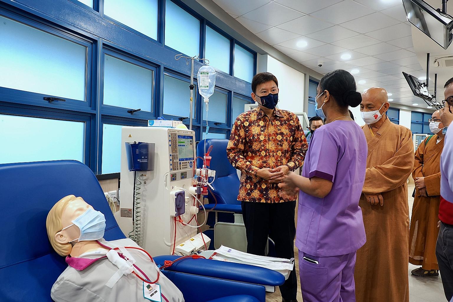 Nurse manager Dolly Ponniyil Poulose explains about the work done at the new Seck Hong Choon-National Kidney Foundation dialysis centre to Senior Minister of State for Foreign Affairs and Transport Chee Hong Tat and abbot of Kong Meng San Phor Kark S