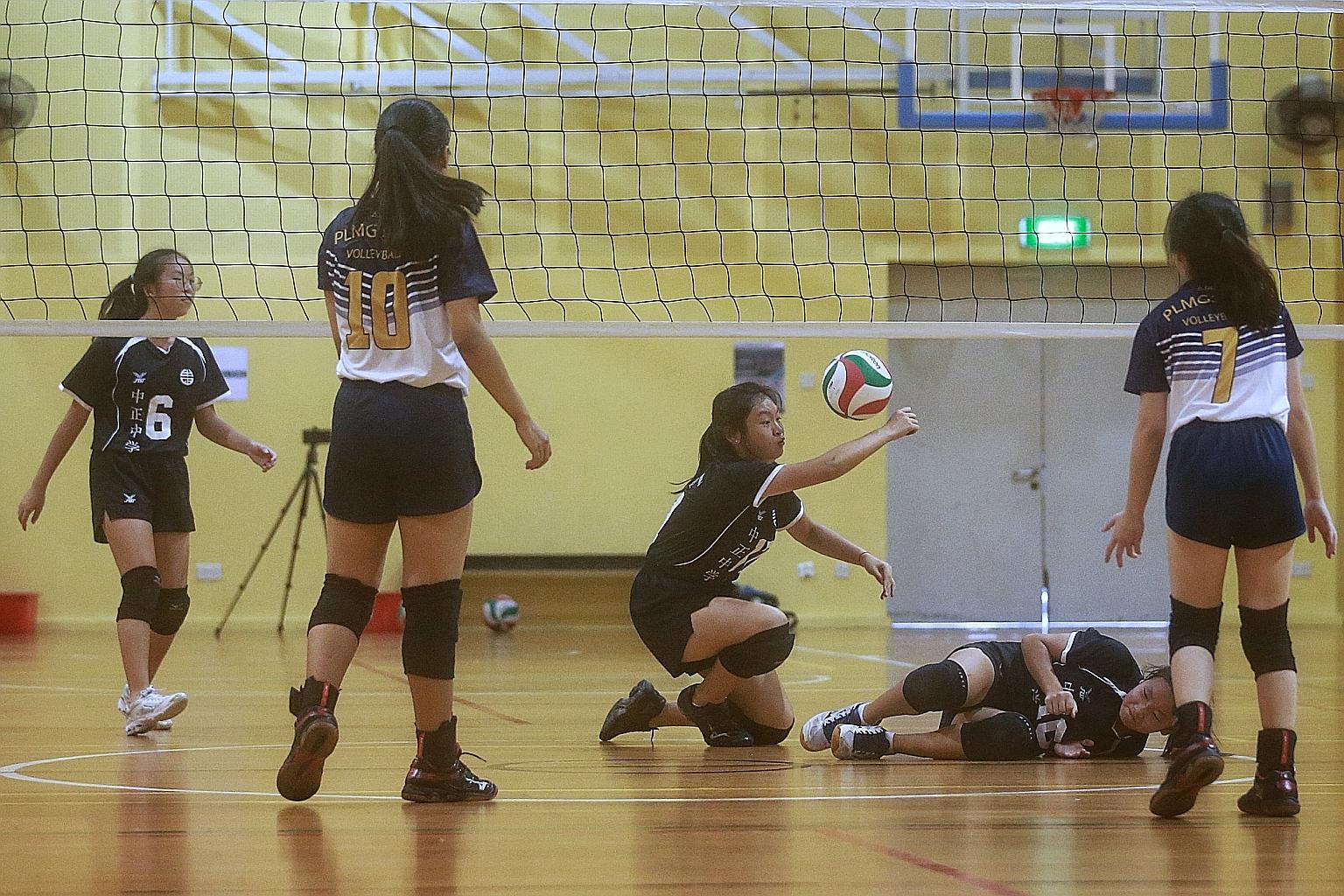 Chung Cheng High School (Main) player Althea Ng (centre) making a save during their girls' B Division volleyball East Zone preliminary round match against Paya Lebar Methodist Girls' School at St Hilda's Secondary yesterday. Chung Cheng lost the 3v3 