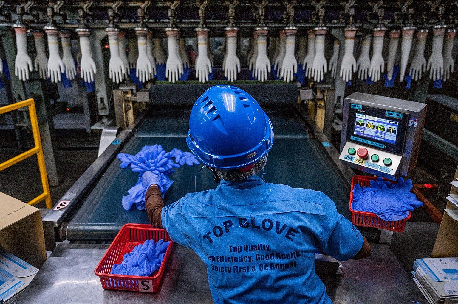 A worker inspecting gloves at a Top Glove factory in Shah Alam on the outskirts of Kuala Lumpur last year.