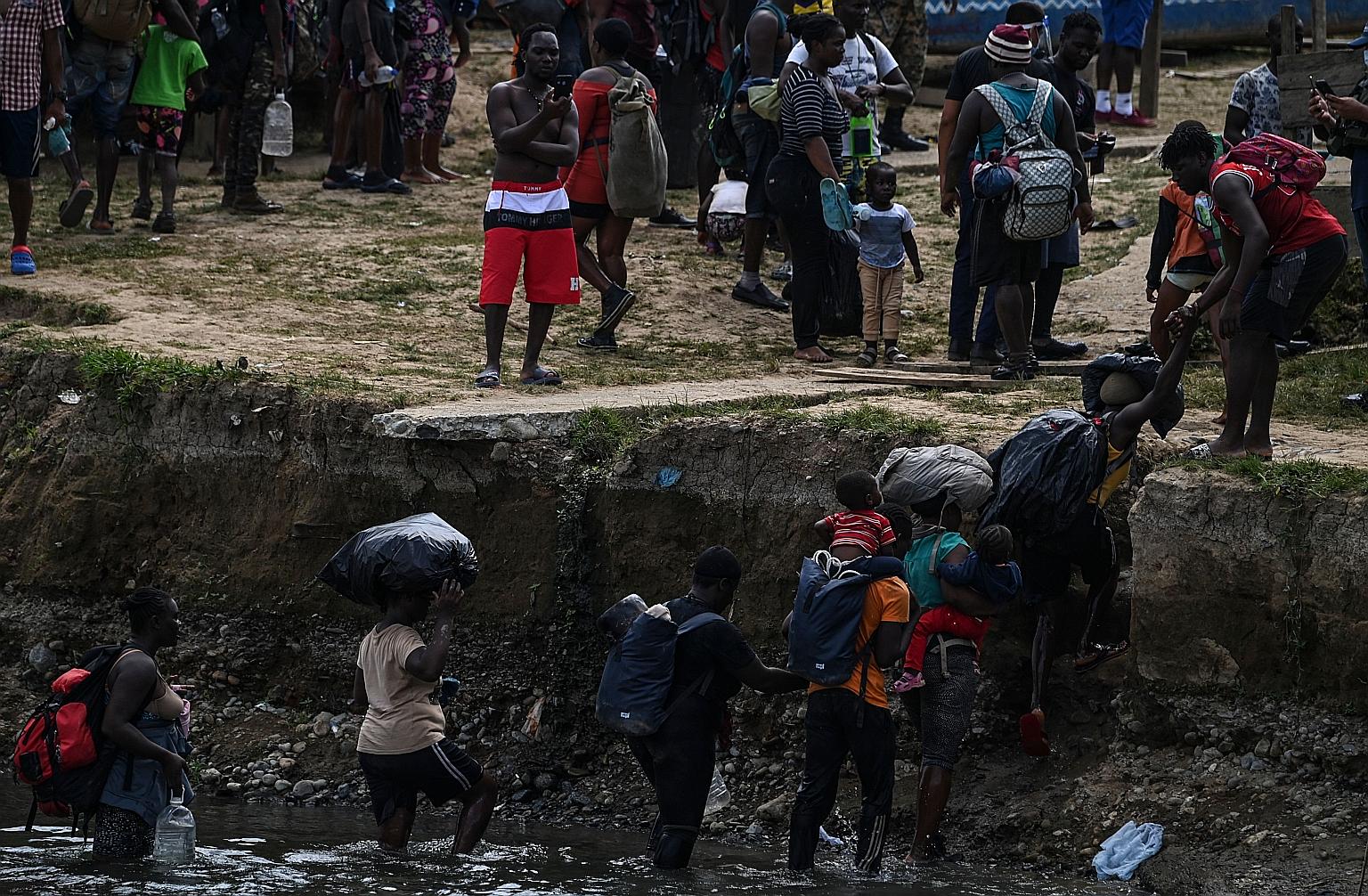Migrants crossing the Chucunaque River last month after walking for five days in the Darien Gap jungle, Panama, on their way to the US. Over the past four years, more than 46,500 migrants, including 6,240 children and adolescents, have crossed the in